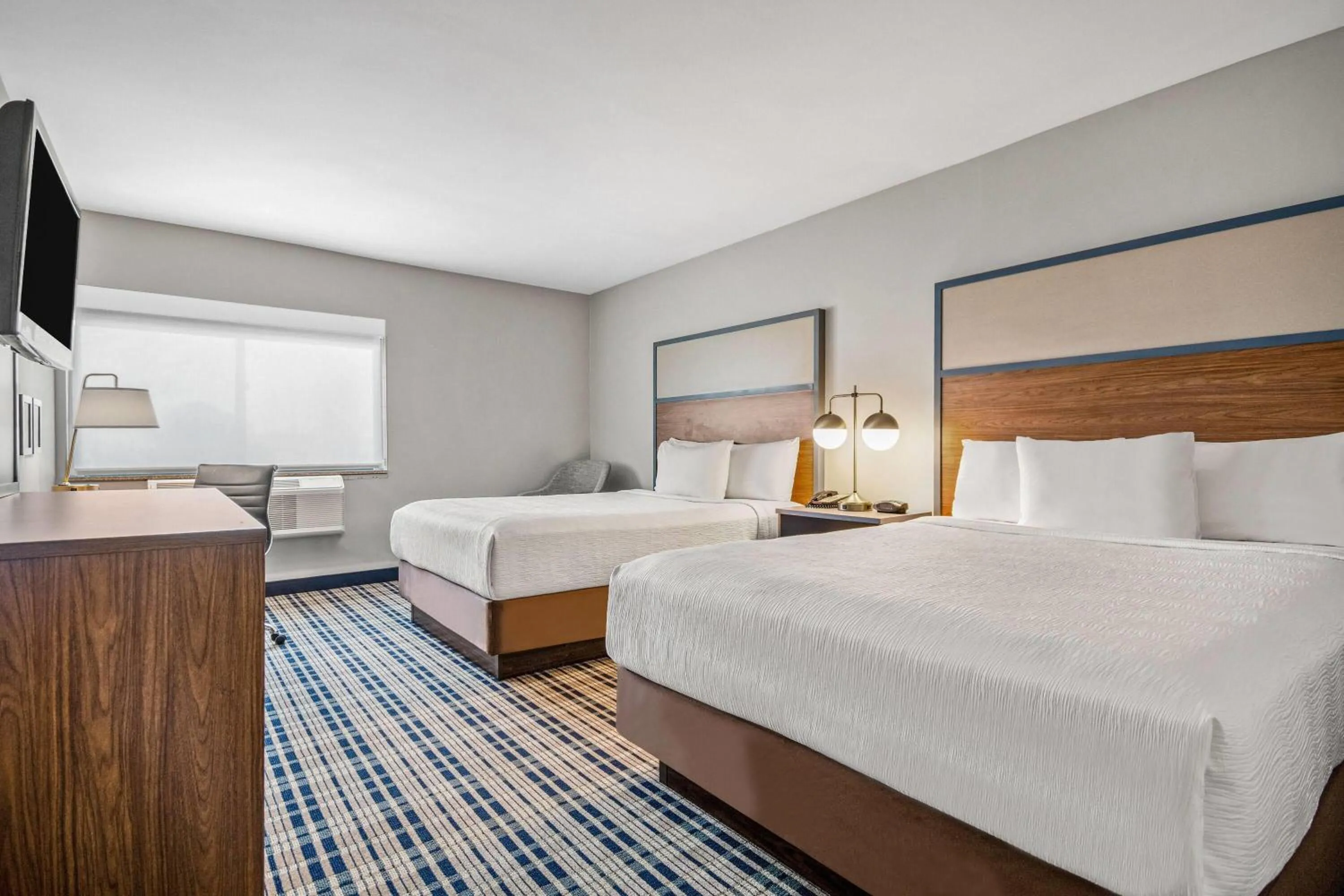 Bed in AmericInn by Wyndham Beloit