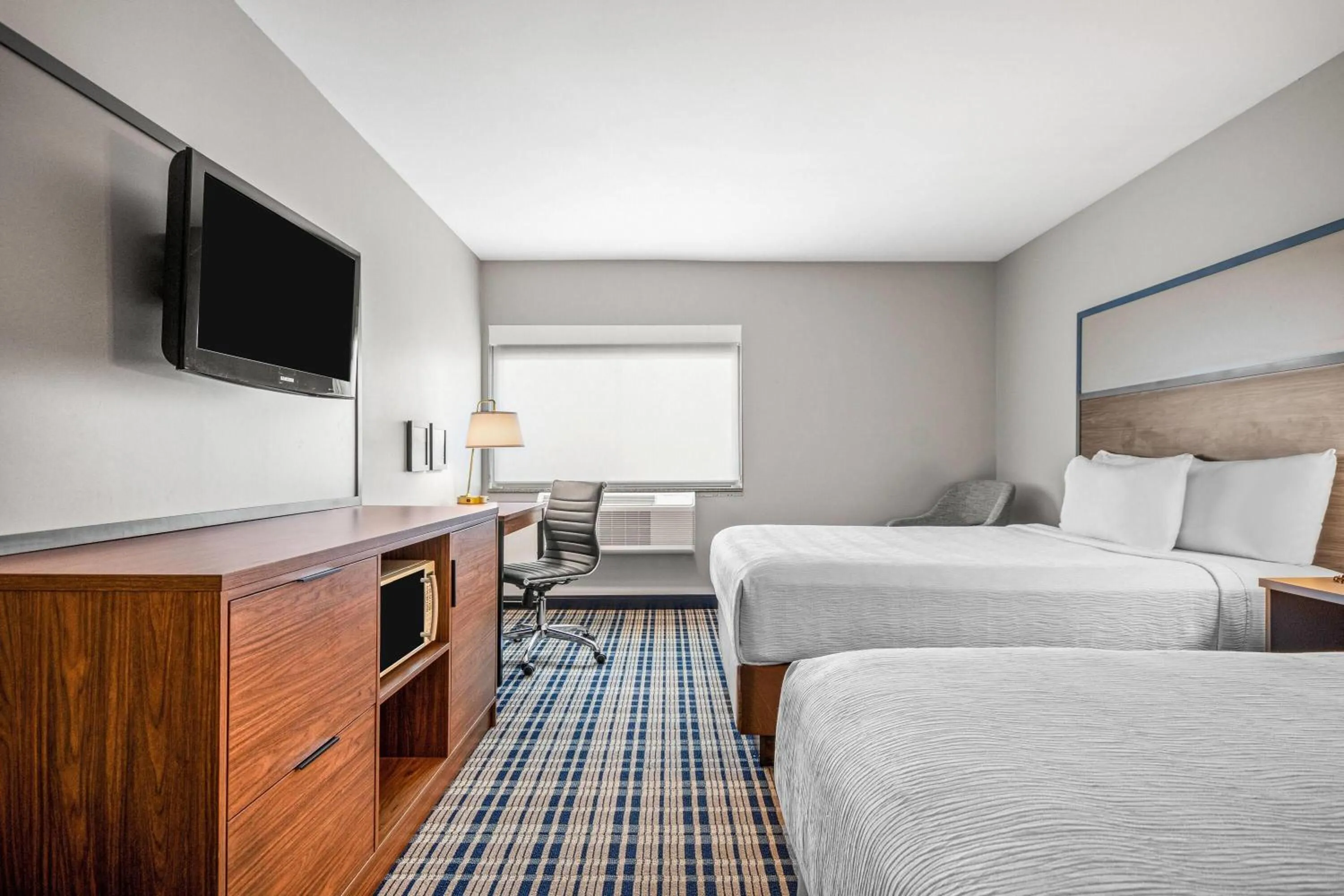 Bed in AmericInn by Wyndham Beloit