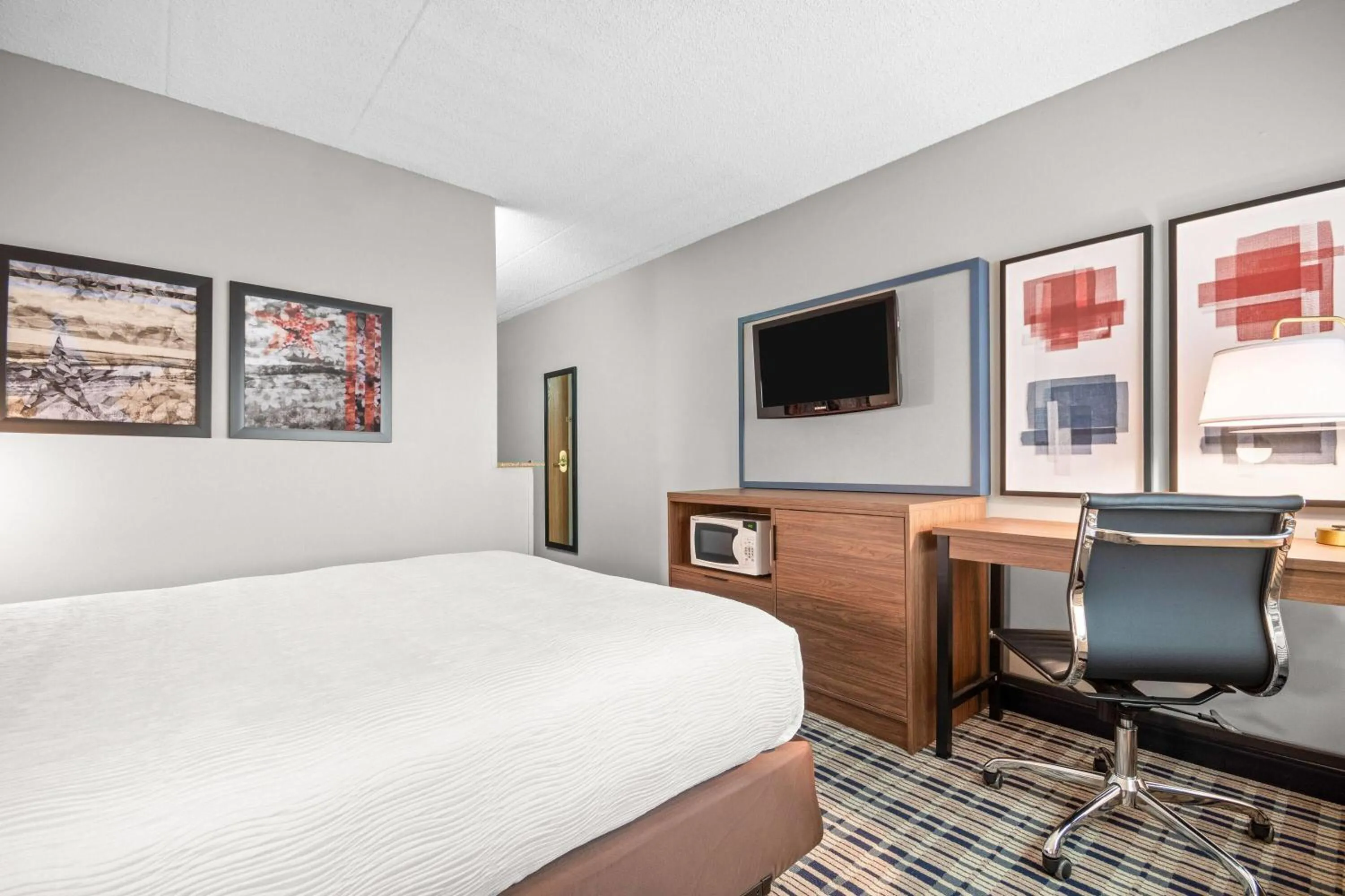 Bed in AmericInn by Wyndham Beloit