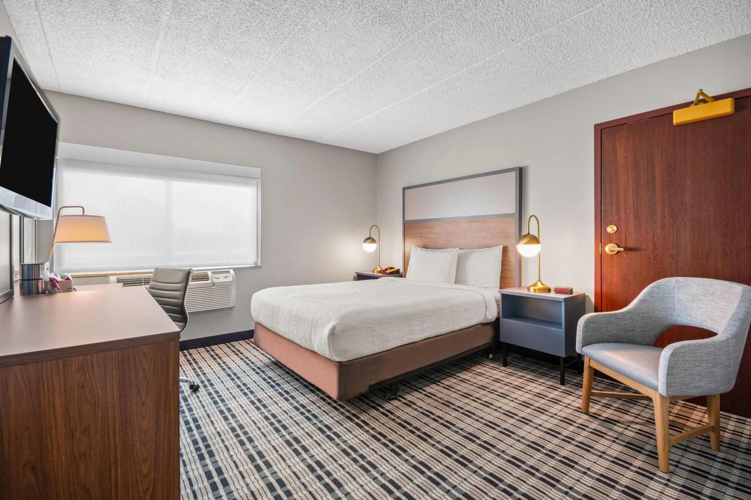 Bed in AmericInn by Wyndham Beloit