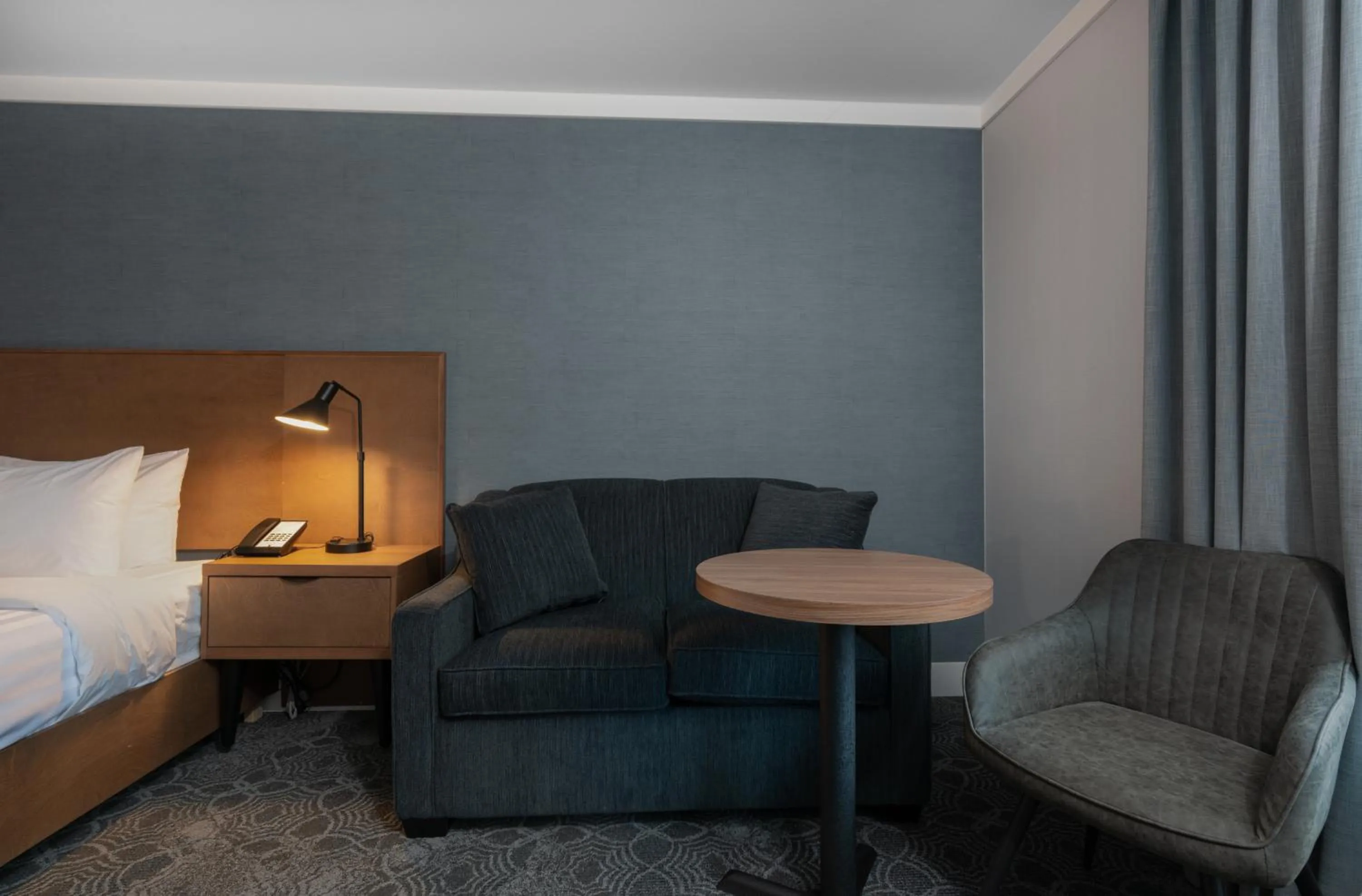 Seating area, Bed in Prestige Kamloops Hotel