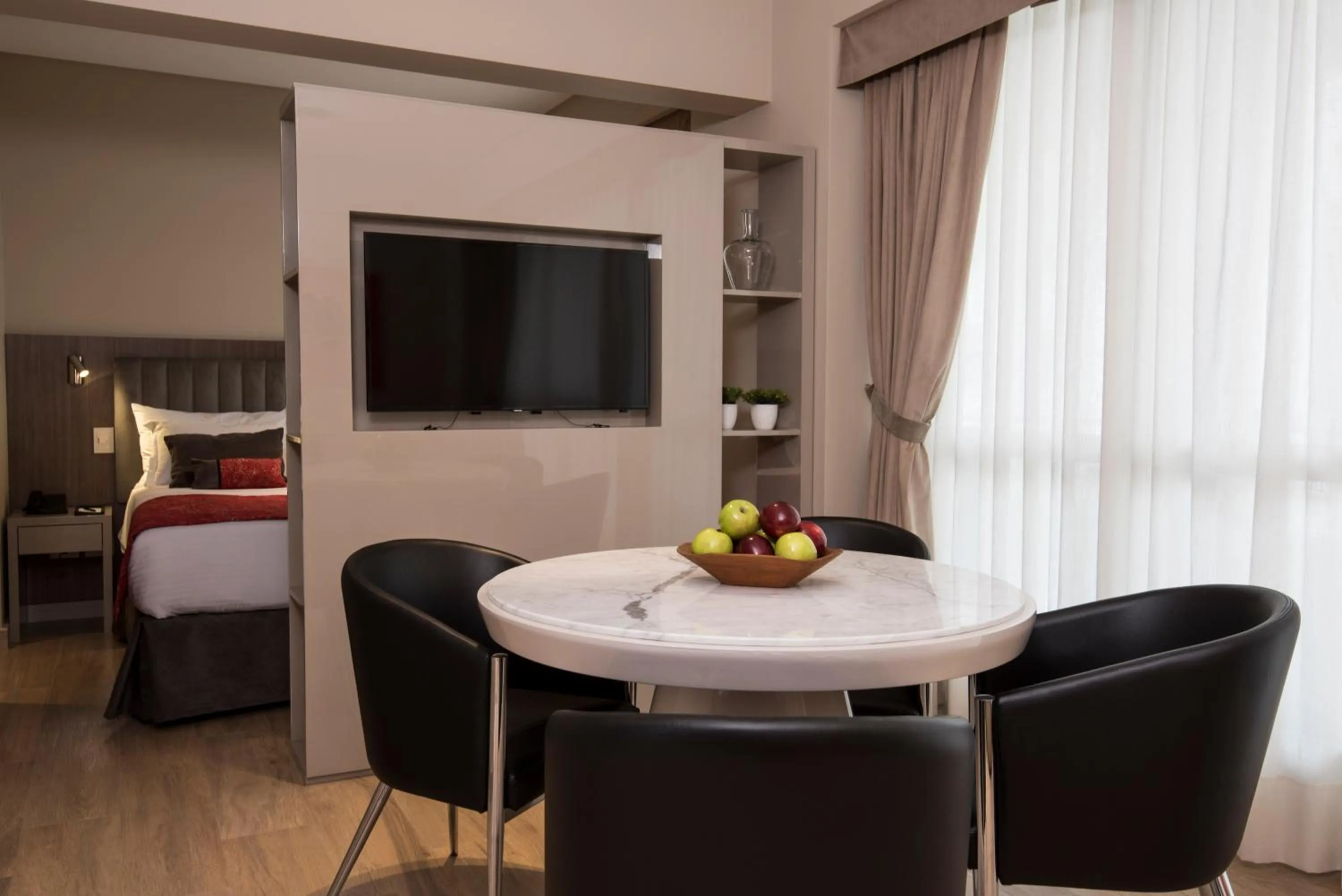 Dining area, Bed in ARC Arenales Studios & Suites
