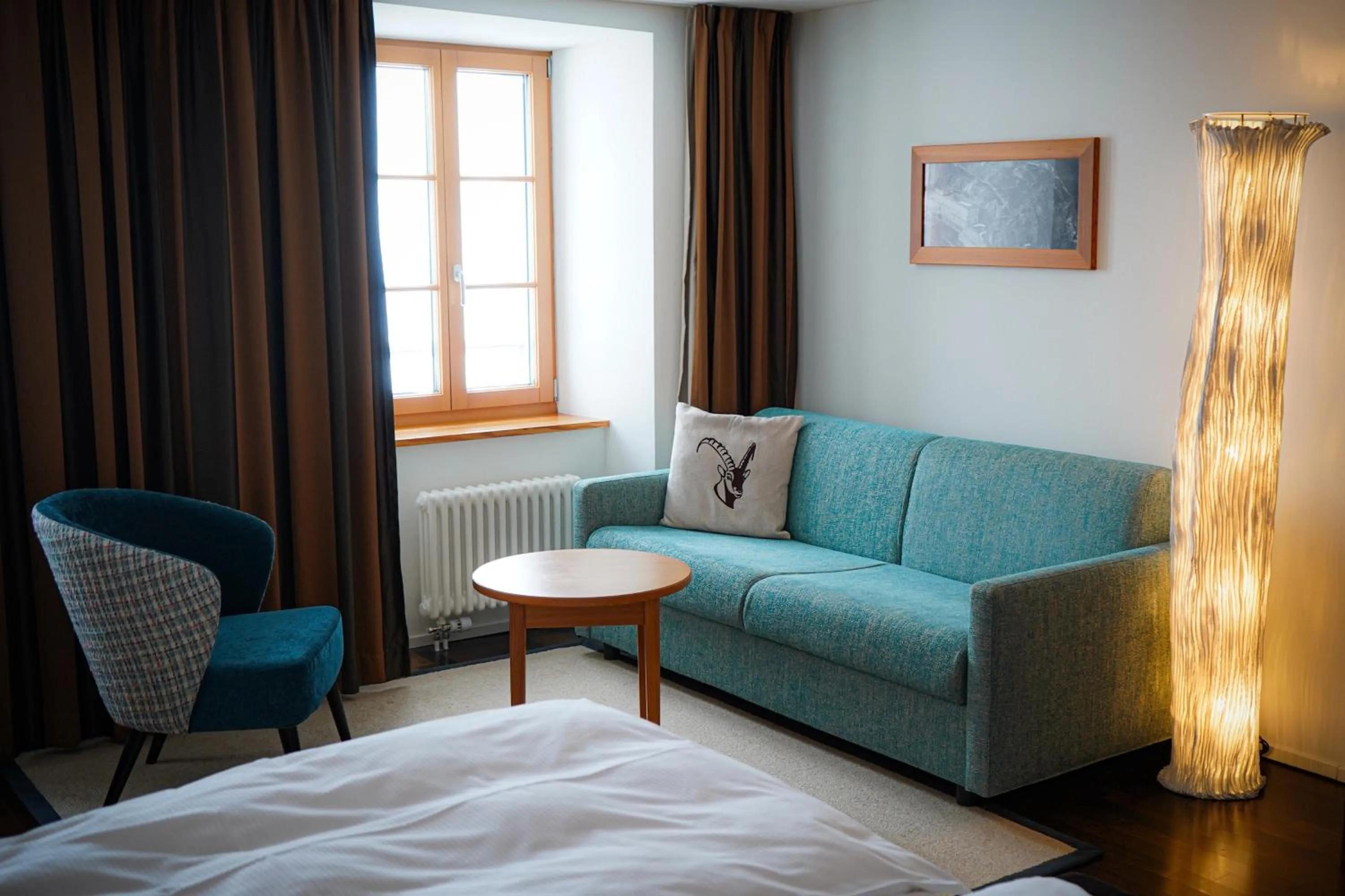 Seating area, Bed in Hotel Pilatus-Kulm