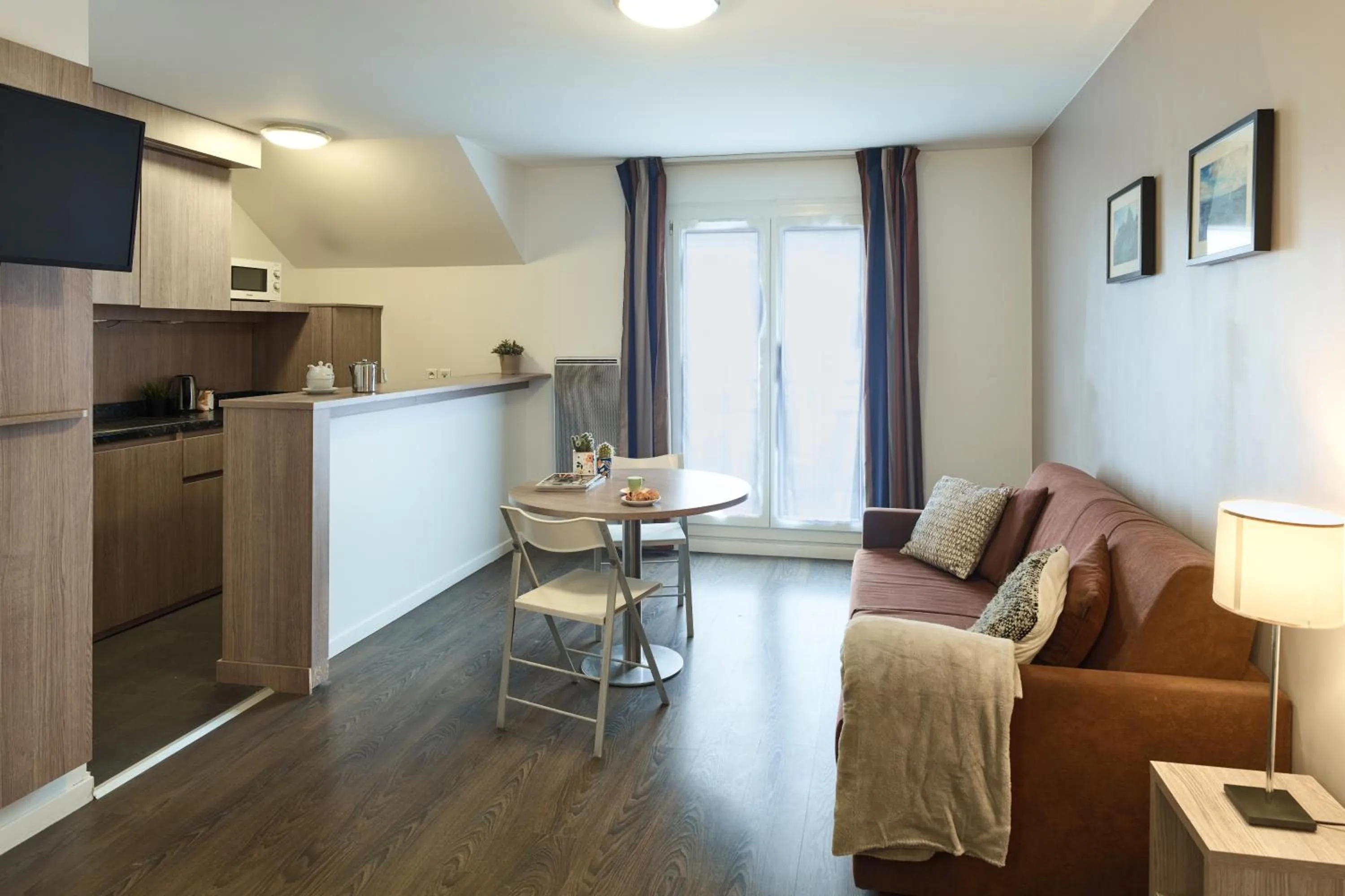 Living room in Zenitude Hôtel Résidences Roissy Village