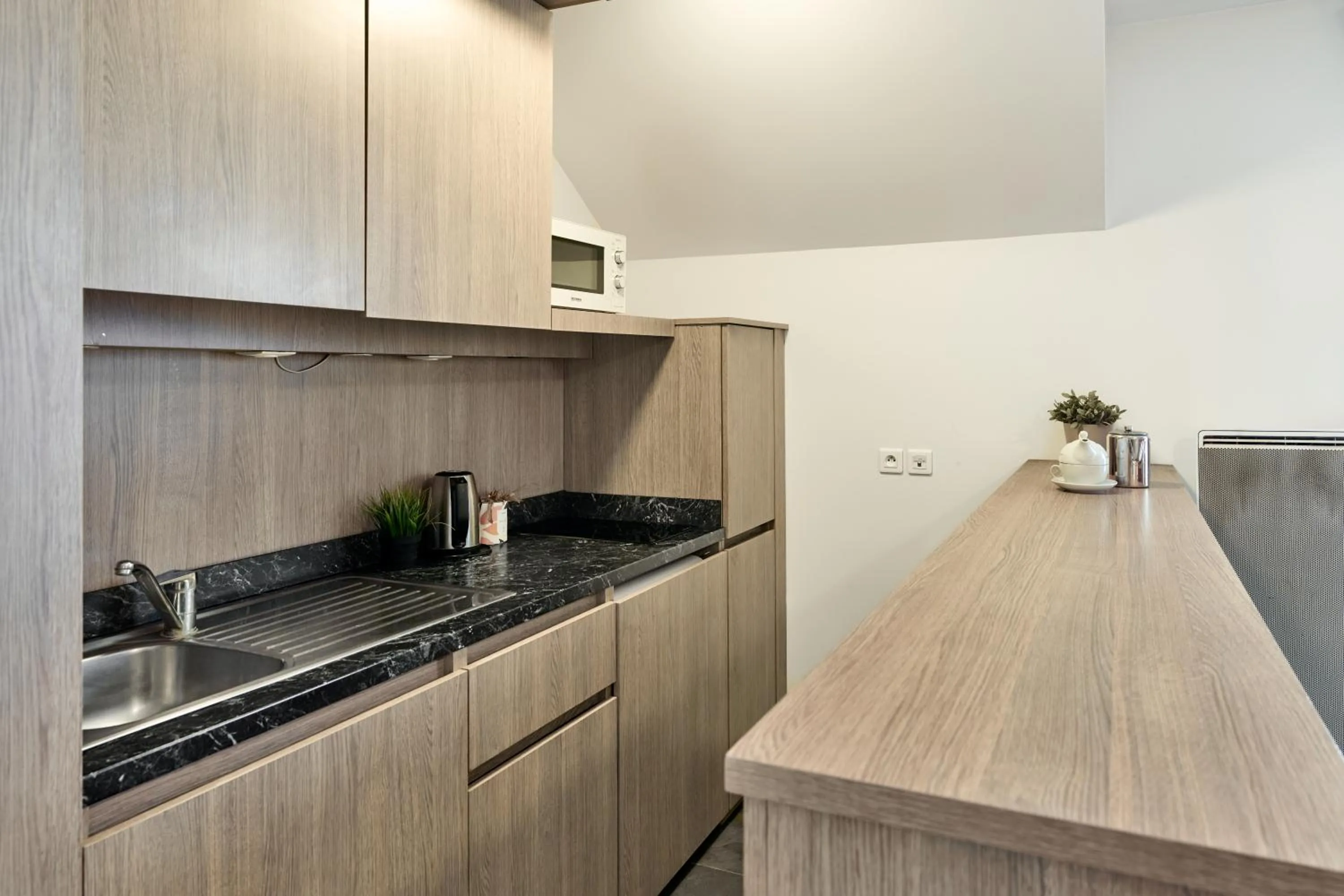 Kitchen or kitchenette in Zenitude Hôtel Résidences Roissy Village