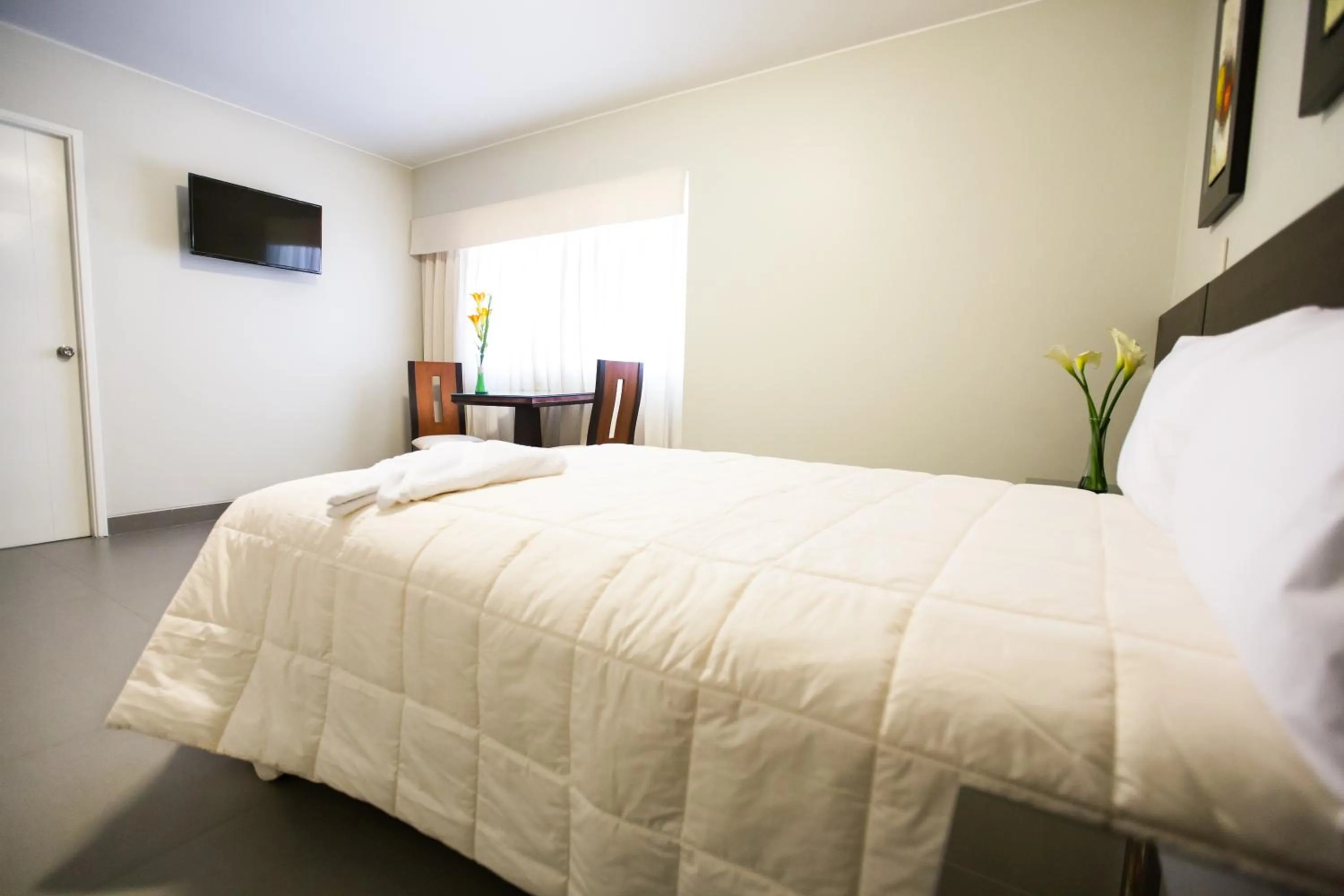 Bed in Mariategui Hotel & Suites