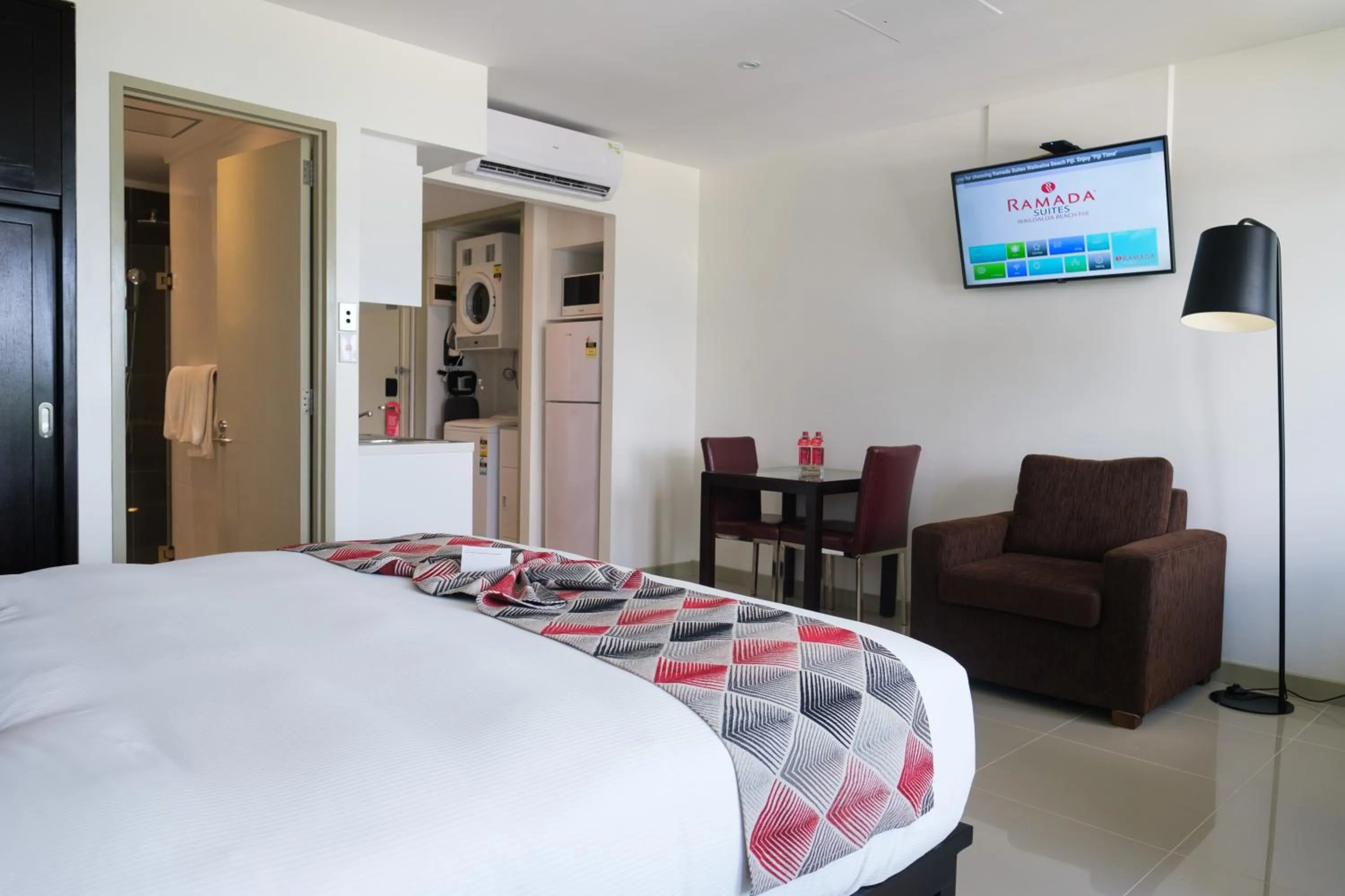 Living room, Bed in Ramada Suites by Wyndham Wailoaloa Beach Fiji