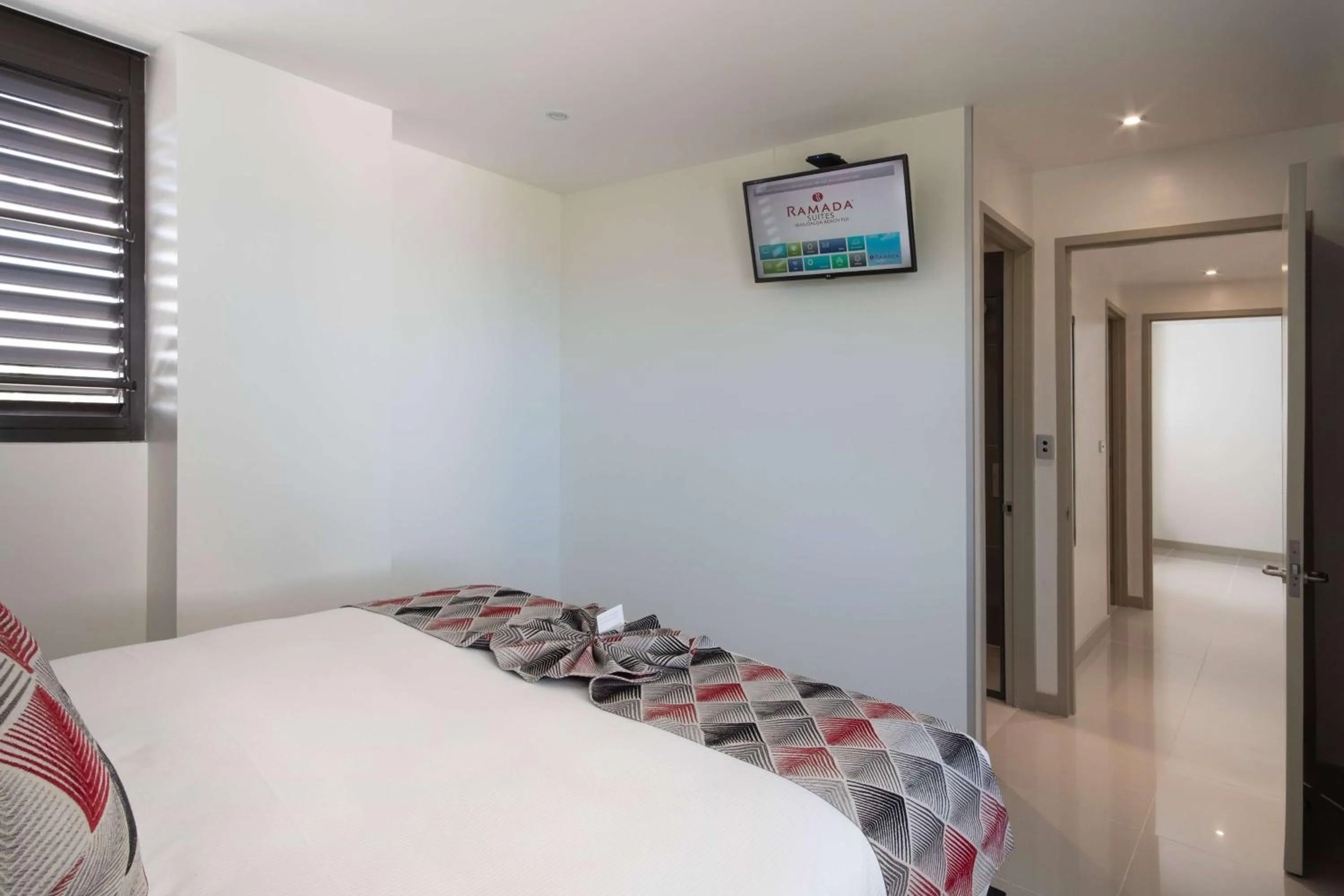 Photo of the whole room, Bed in Ramada Suites by Wyndham Wailoaloa Beach Fiji