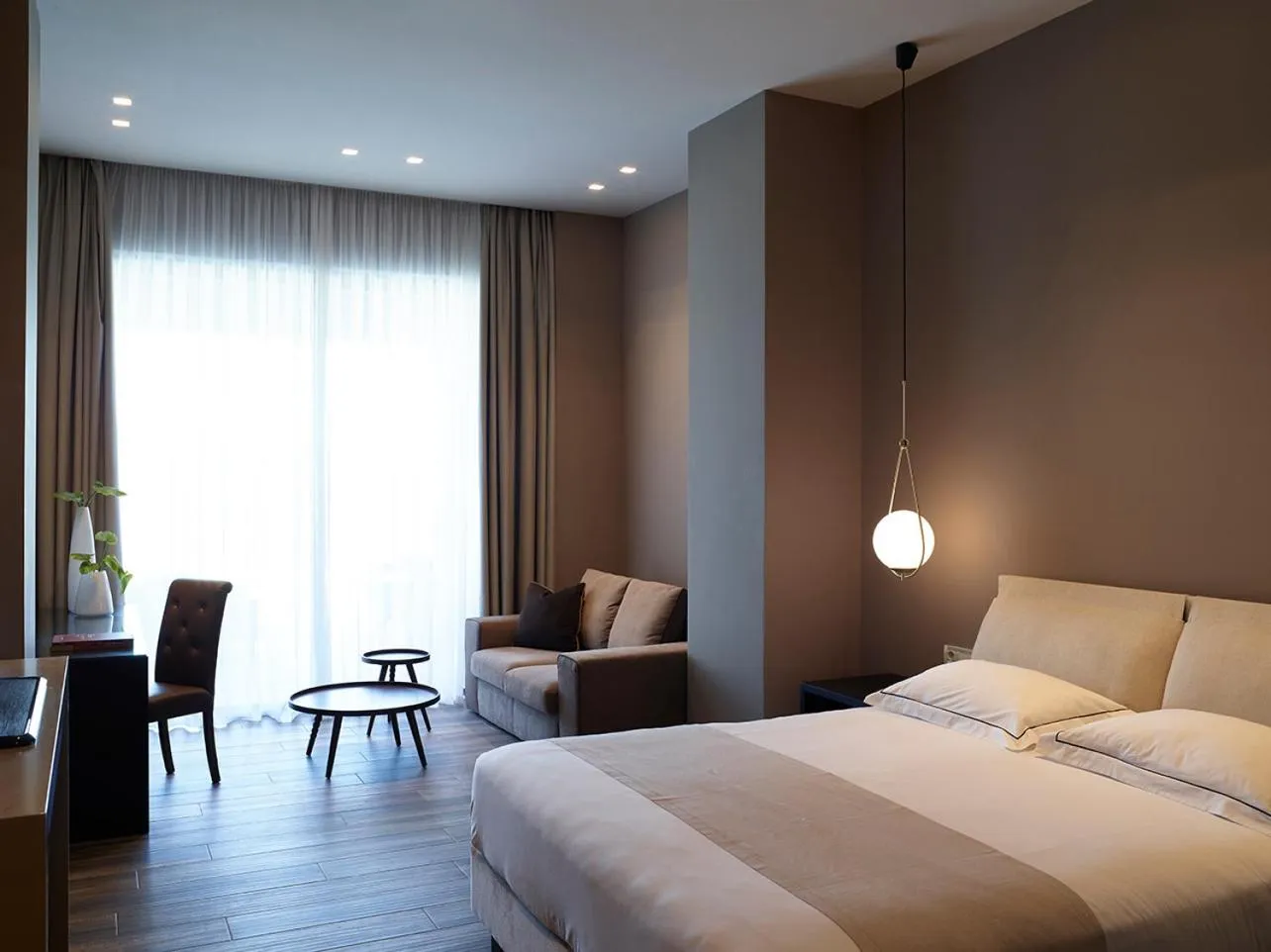 Photo of the whole room, Bed in Pelagos Suites Hotel & Spa