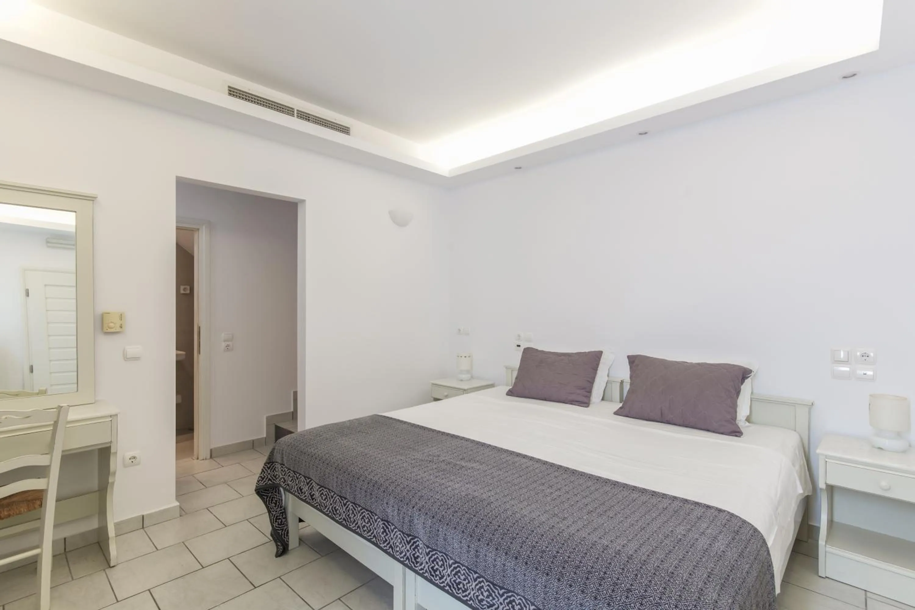 Bed in Alexandros Apartments