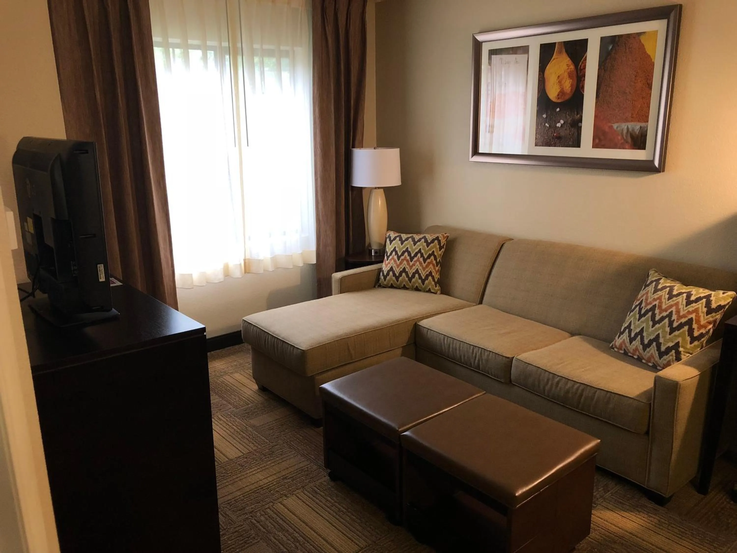 Communal lounge/ TV room in Staybridge Suites Grand Rapids-Kentwood by IHG