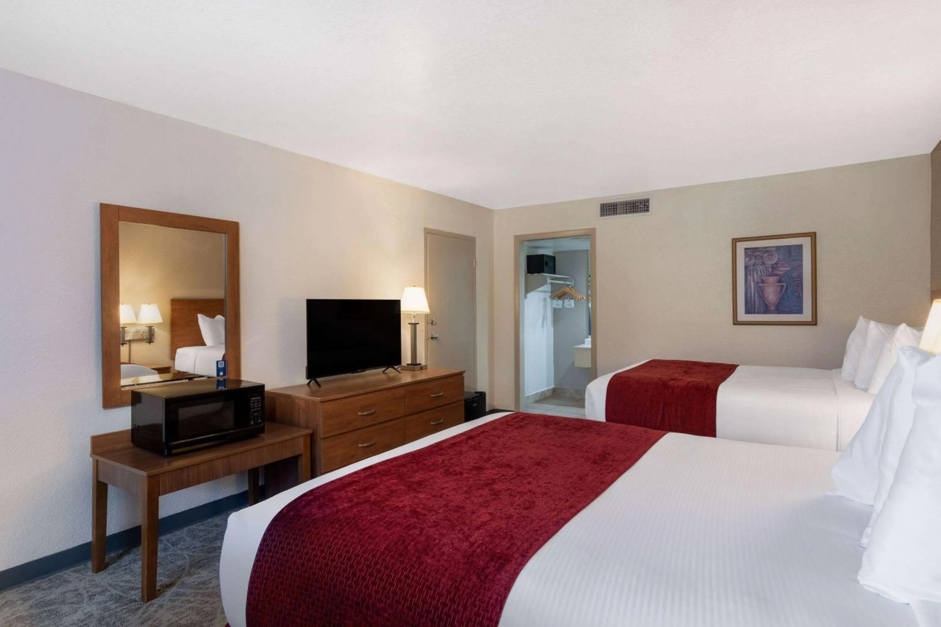 Photo of the whole room, Bed in Ramada by Wyndham Kissimmee Gateway - Free Theme Park Shuttle