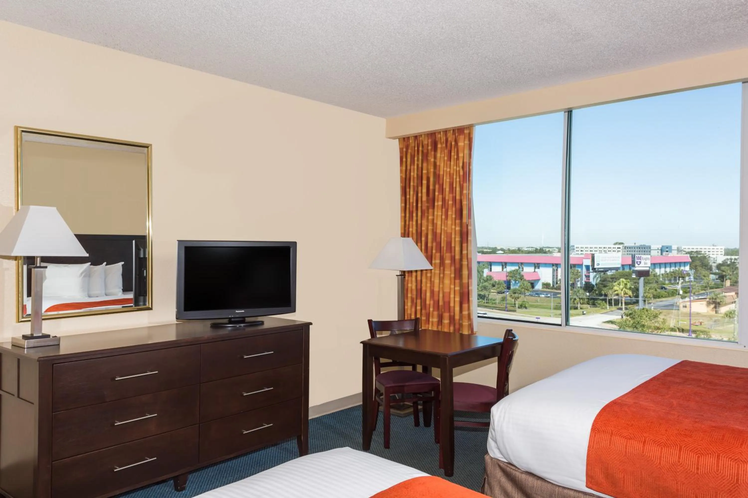 TV and multimedia, Bed in Ramada by Wyndham Kissimmee Gateway - Free Theme Park Shuttle