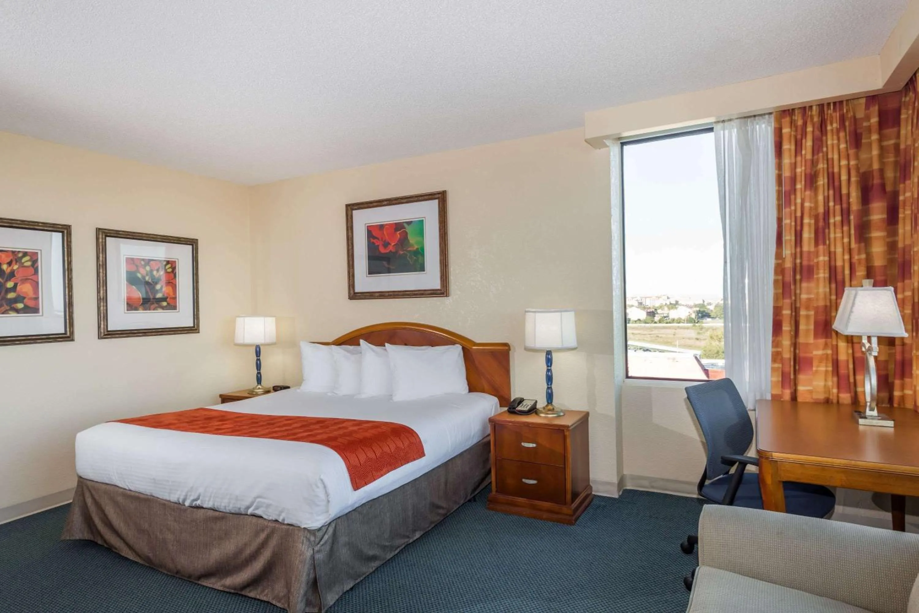 Photo of the whole room, Bed in Ramada by Wyndham Kissimmee Gateway - Free Theme Park Shuttle