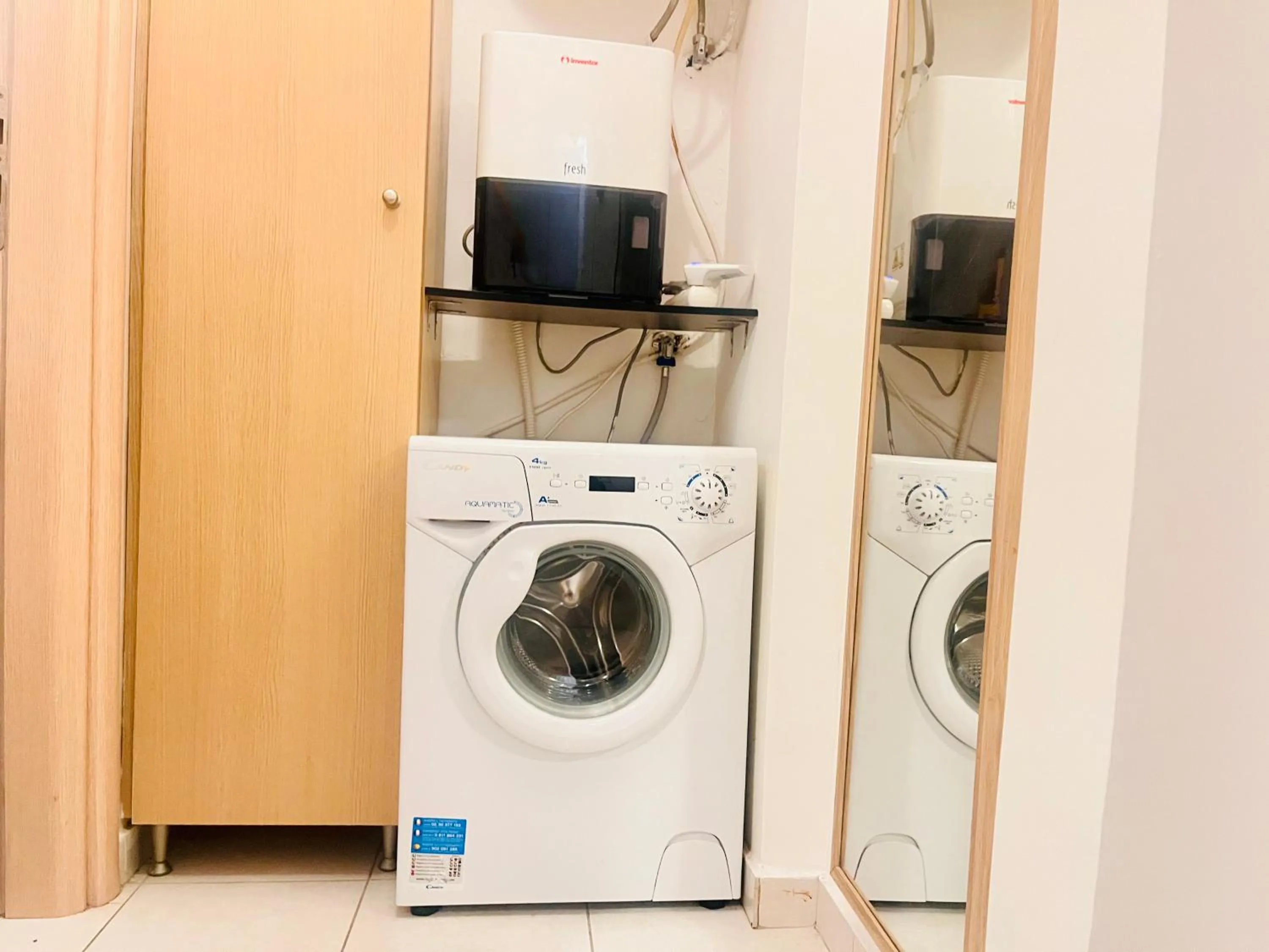 washing machine in Elvita Apartments