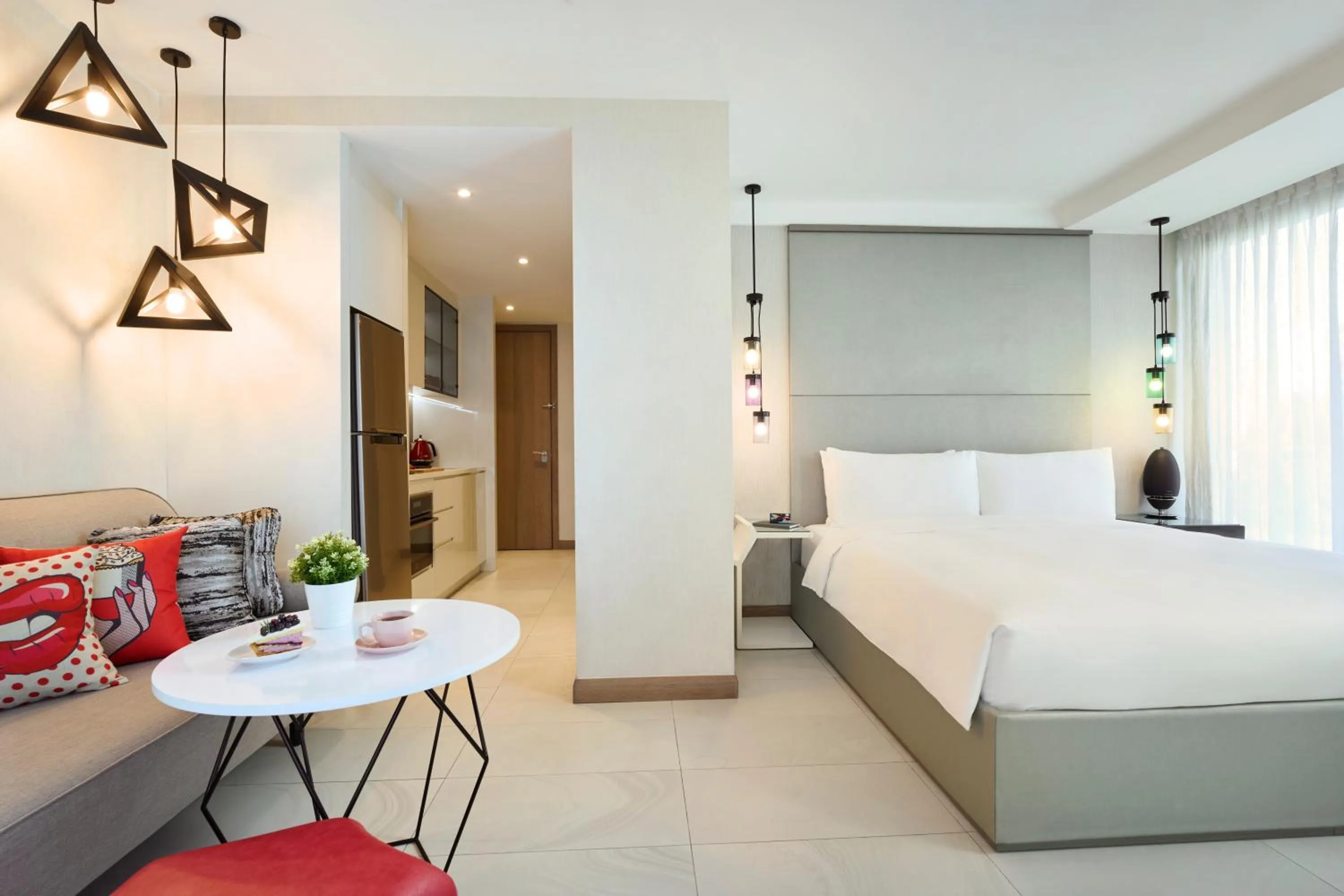 Living room, Bed in Oakwood Studios Singapore