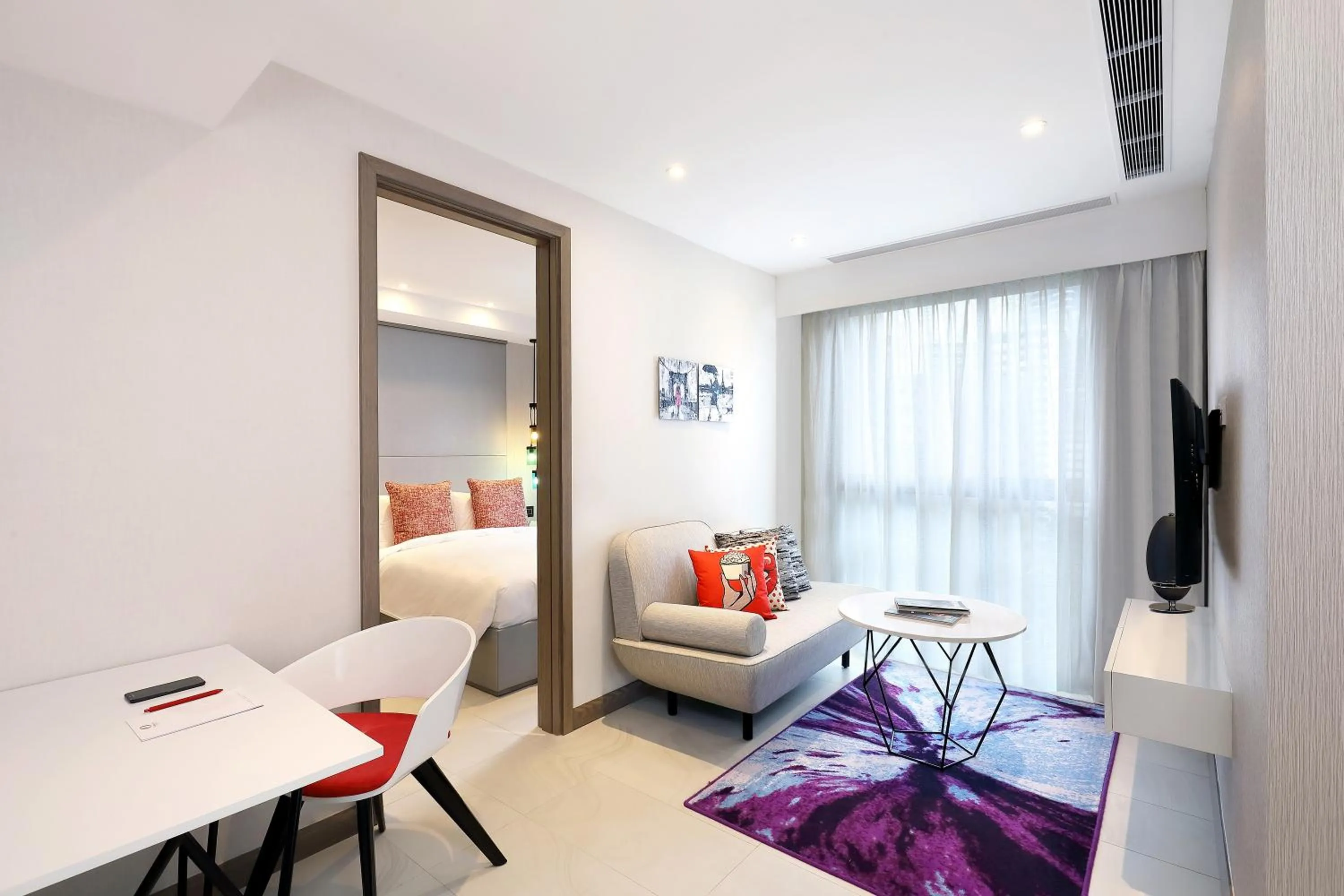 Living room, Bed in Oakwood Studios Singapore