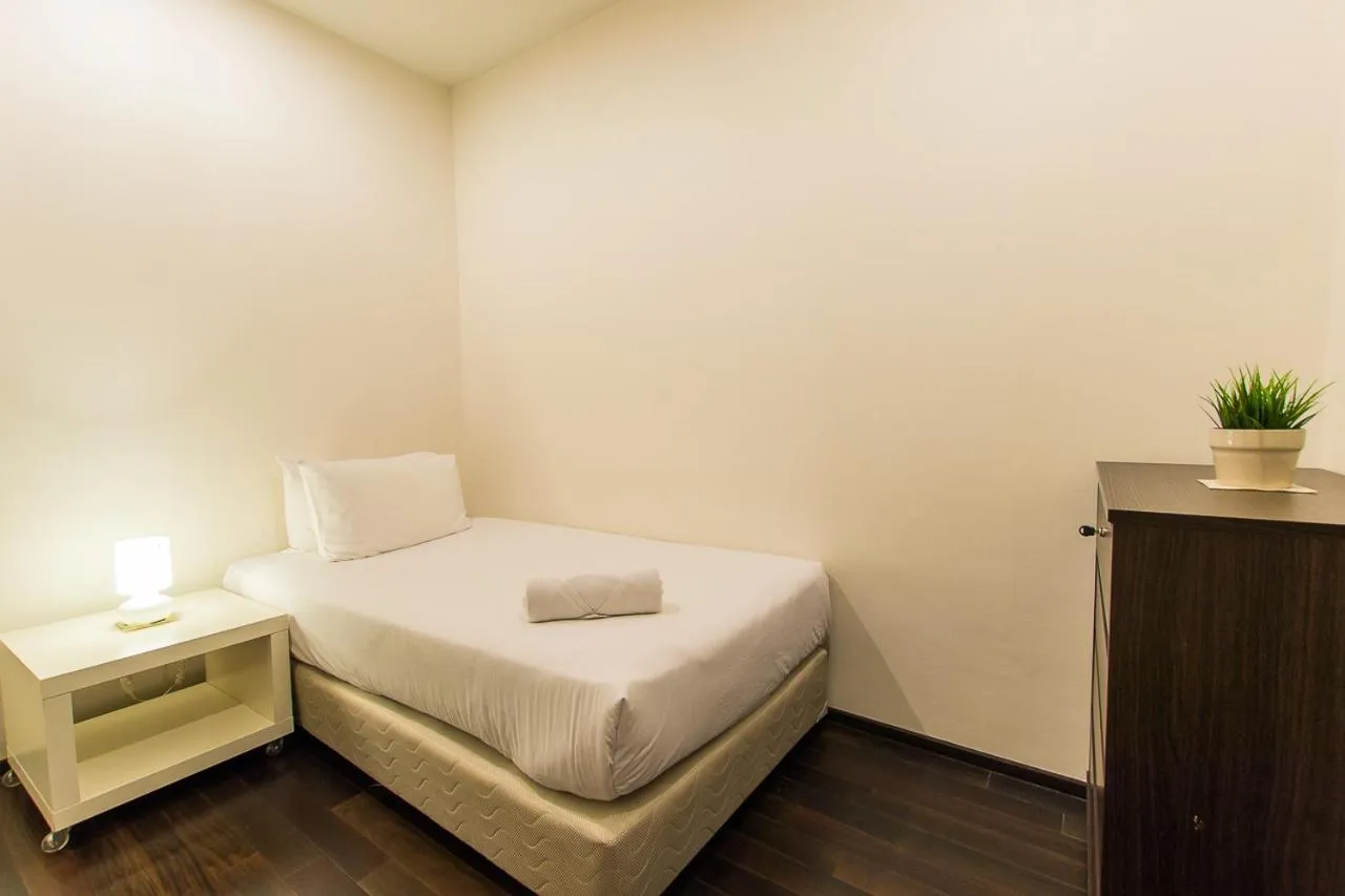 Bed in The Title Comfort Condotel