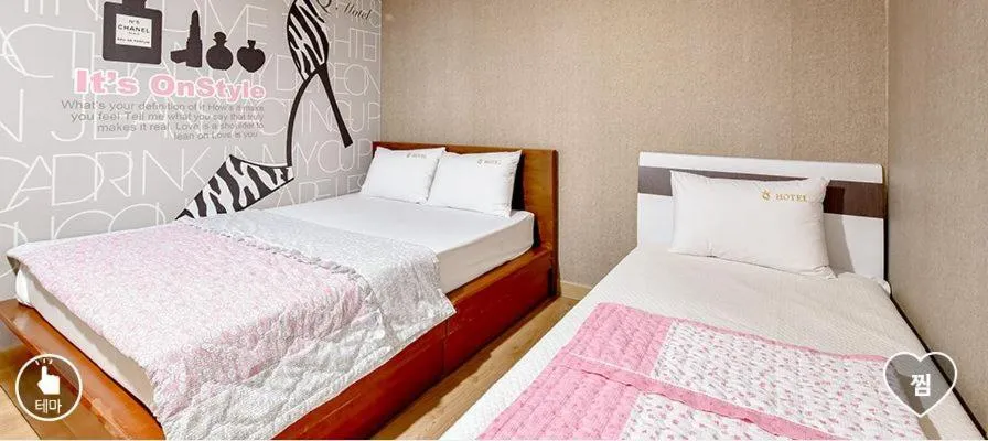 Bed in Happy Q Motel