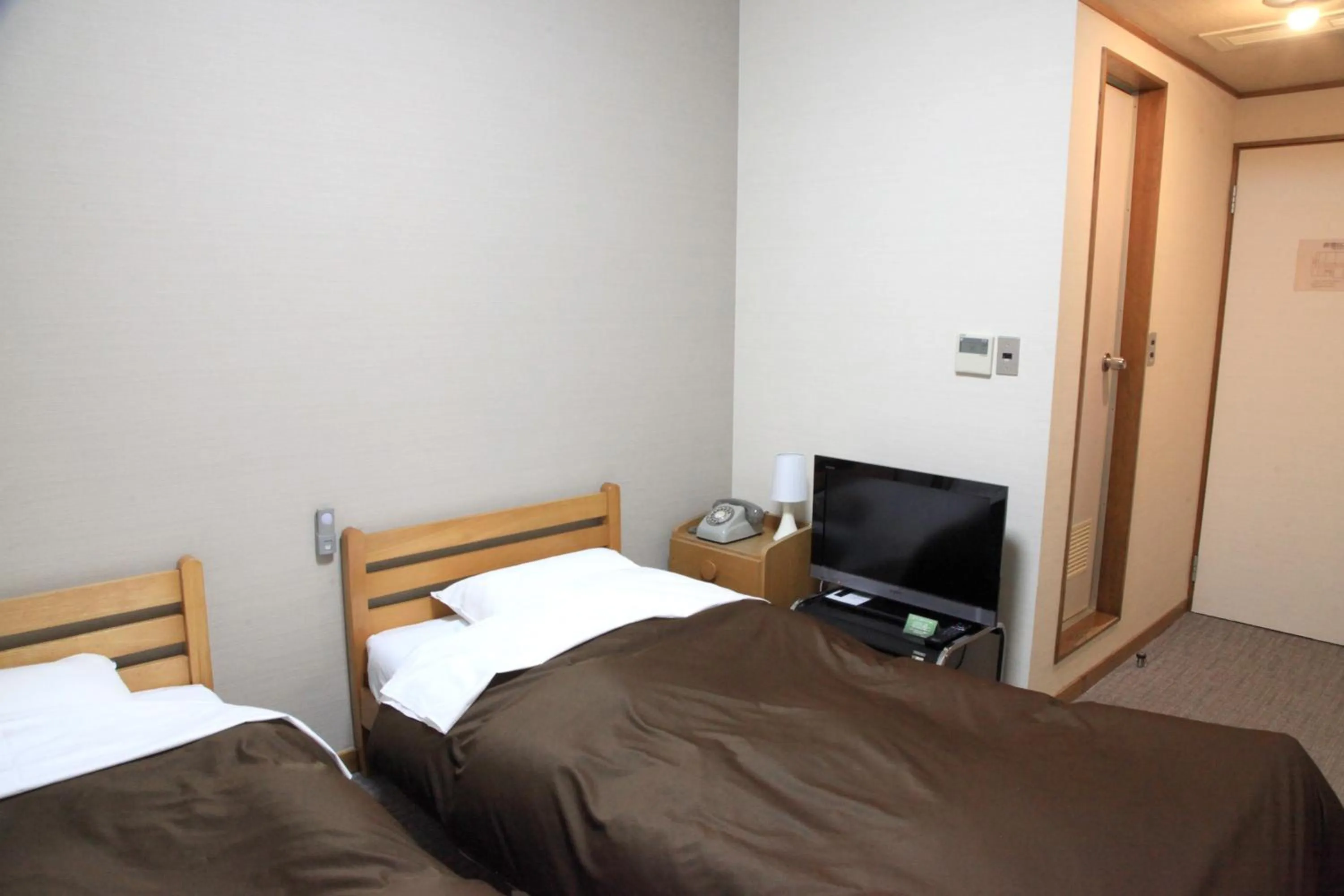 Bed in Hotel New Kotobuki