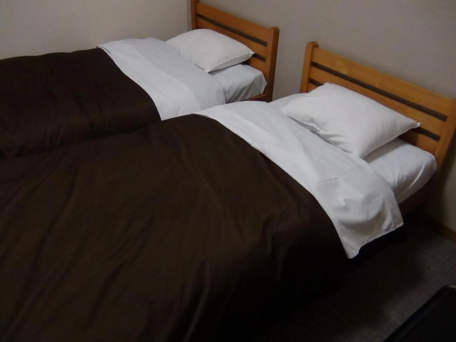 Bed in Hotel New Kotobuki