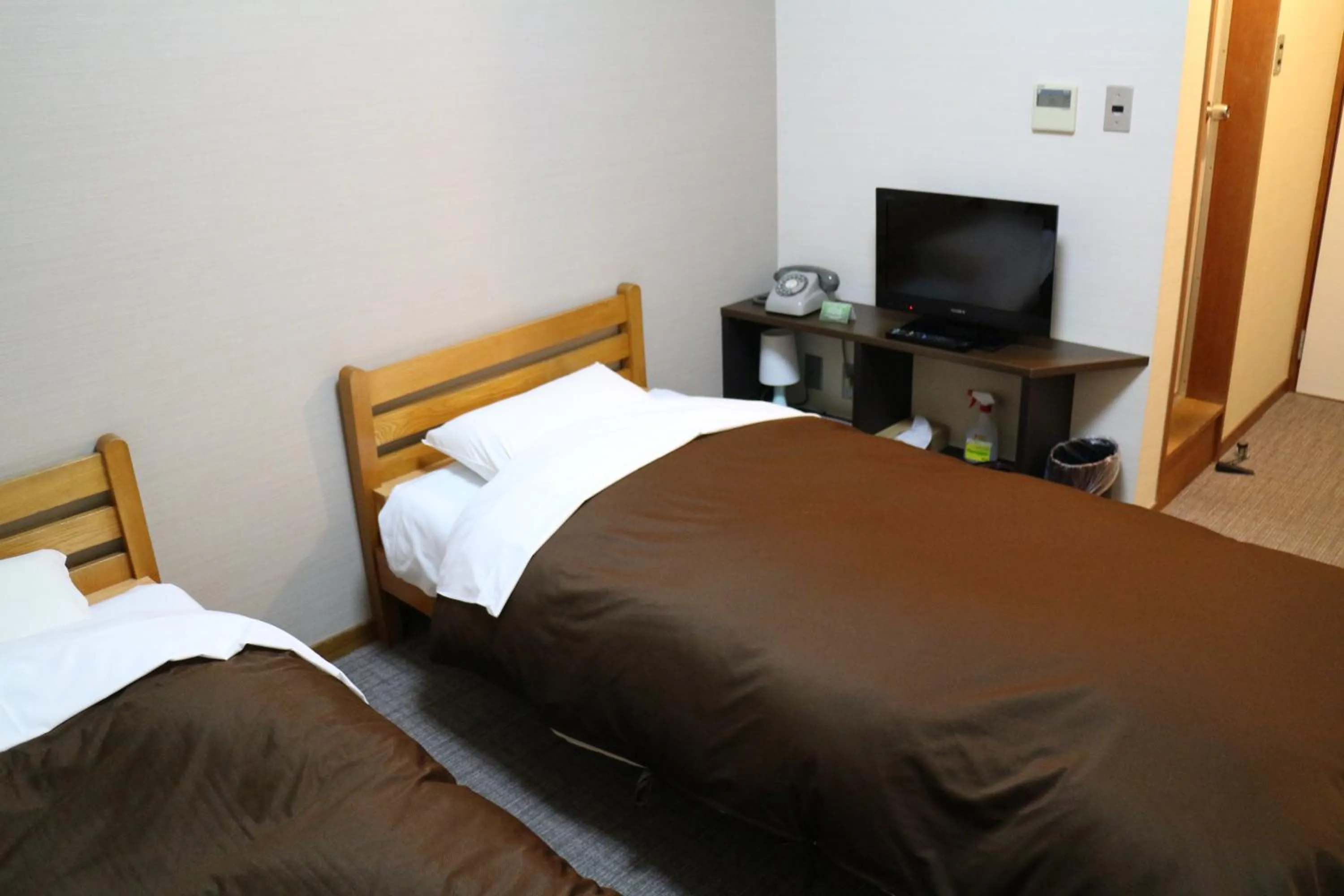 Bed in Hotel New Kotobuki