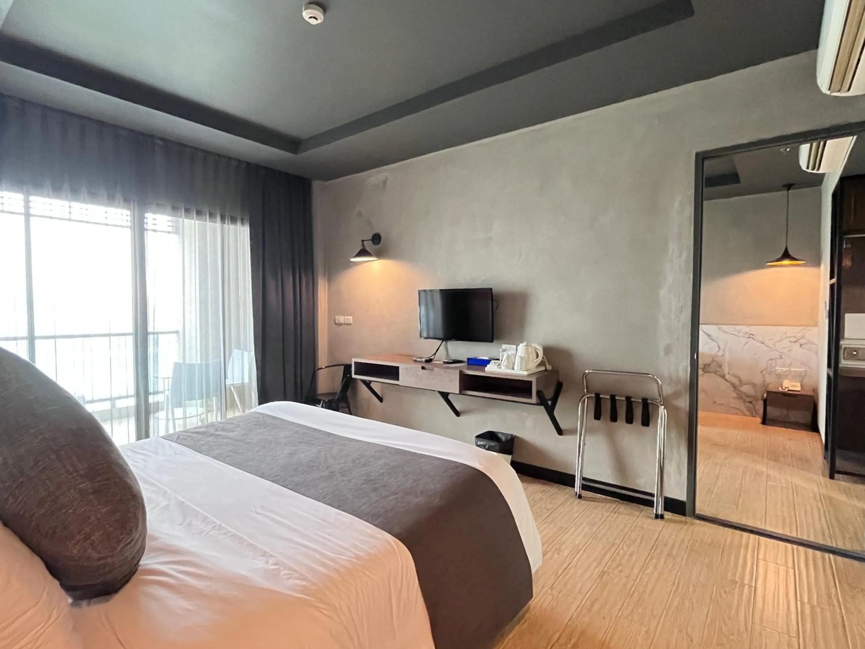 Bed in Chiangkhong Teak Garden Riverfront Onsen Hotel- SHA Extra Plus