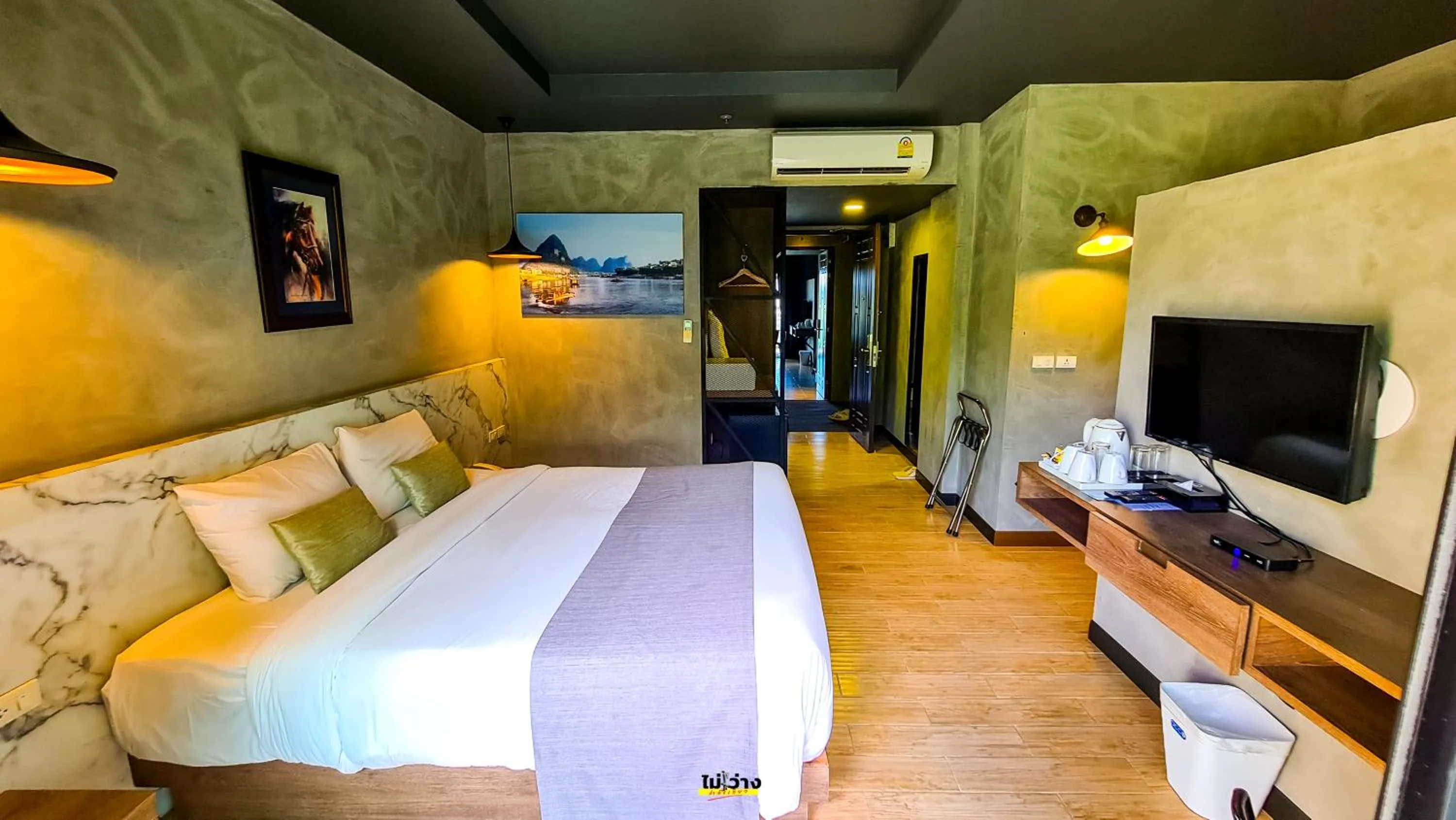 Bed in Chiangkhong Teak Garden Riverfront Onsen Hotel- SHA Extra Plus