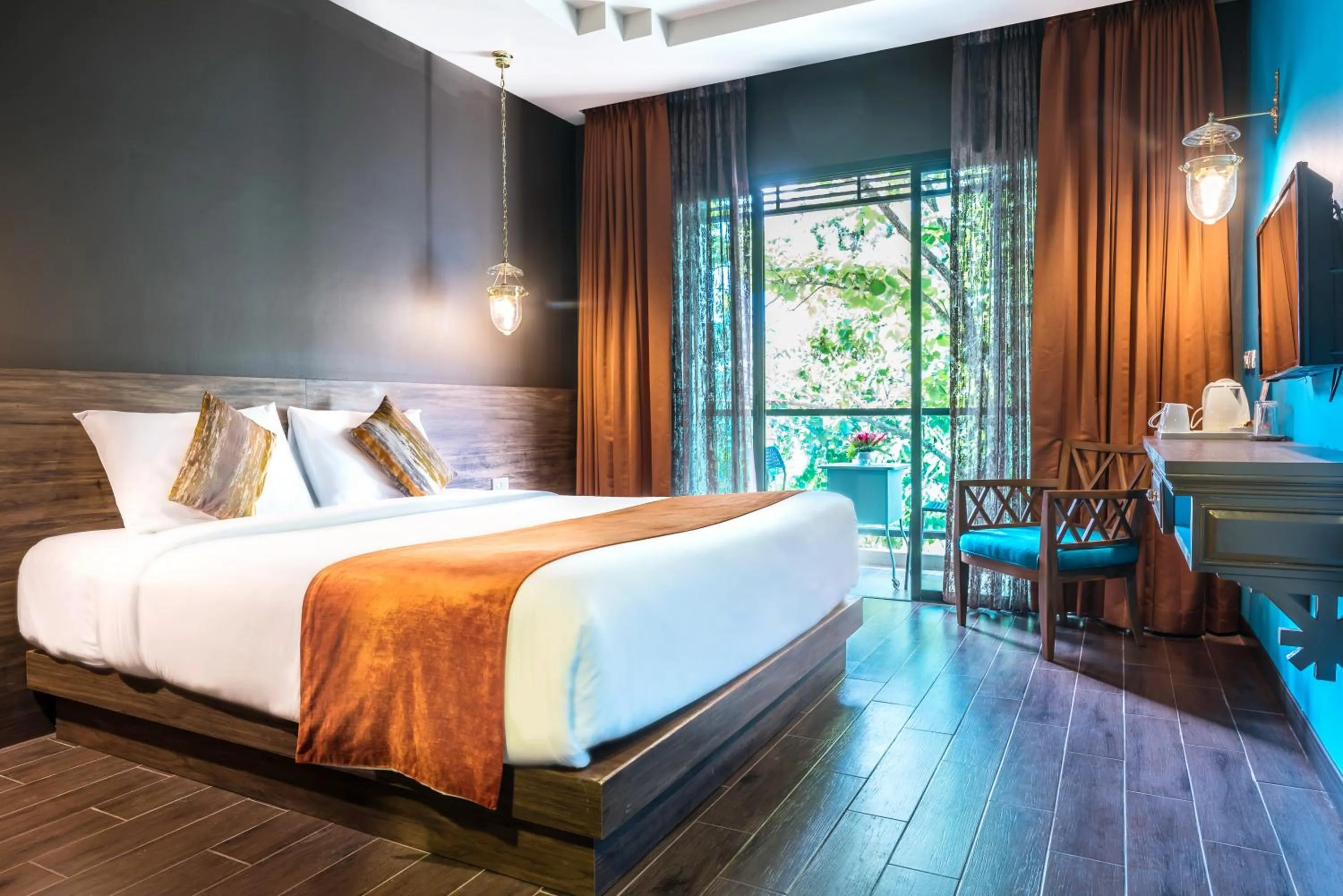 Bed in Chiangkhong Teak Garden Riverfront Onsen Hotel- SHA Extra Plus