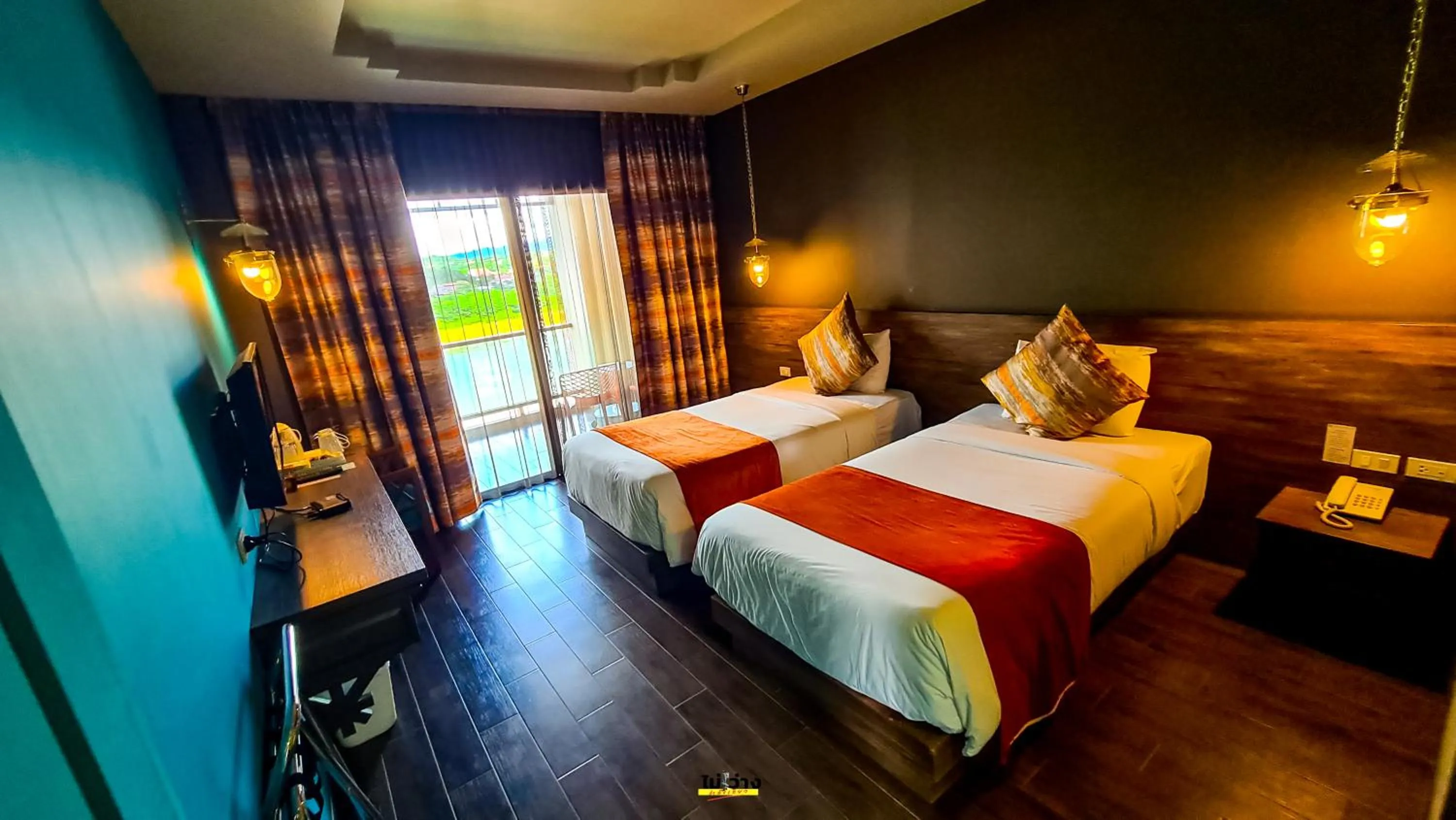 Bed in Chiangkhong Teak Garden Riverfront Onsen Hotel- SHA Extra Plus
