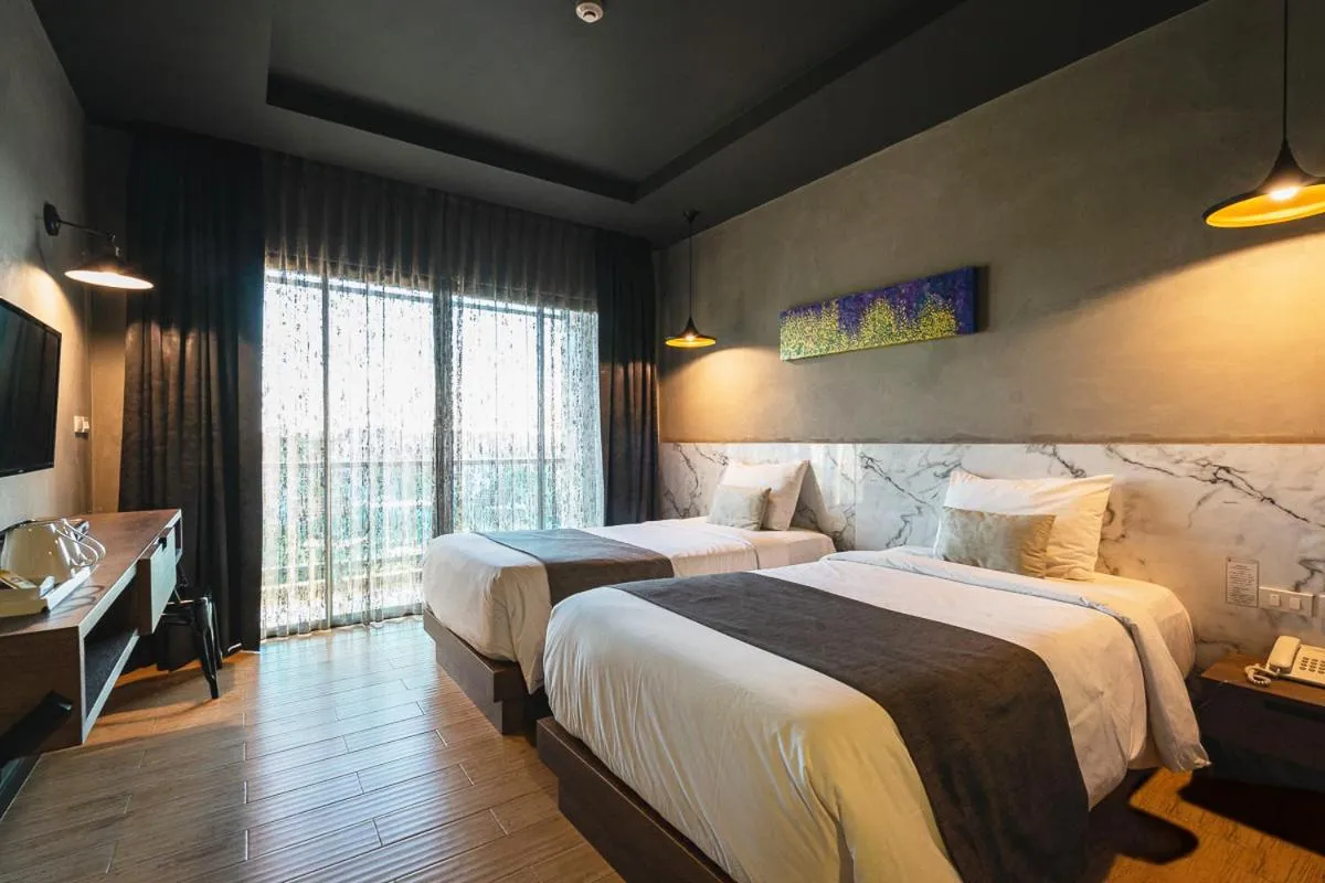 Bed in Chiangkhong Teak Garden Riverfront Onsen Hotel- SHA Extra Plus