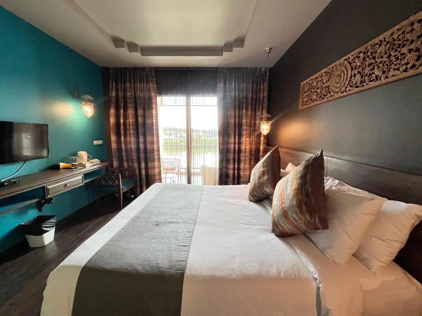 Bed in Chiangkhong Teak Garden Riverfront Onsen Hotel- SHA Extra Plus