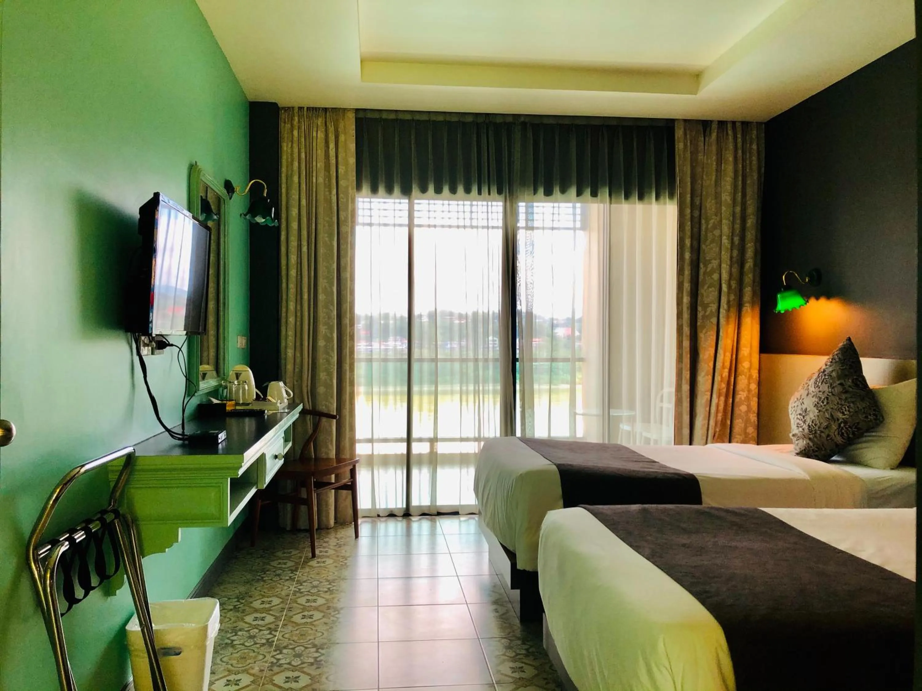 Bed in Chiangkhong Teak Garden Riverfront Onsen Hotel- SHA Extra Plus