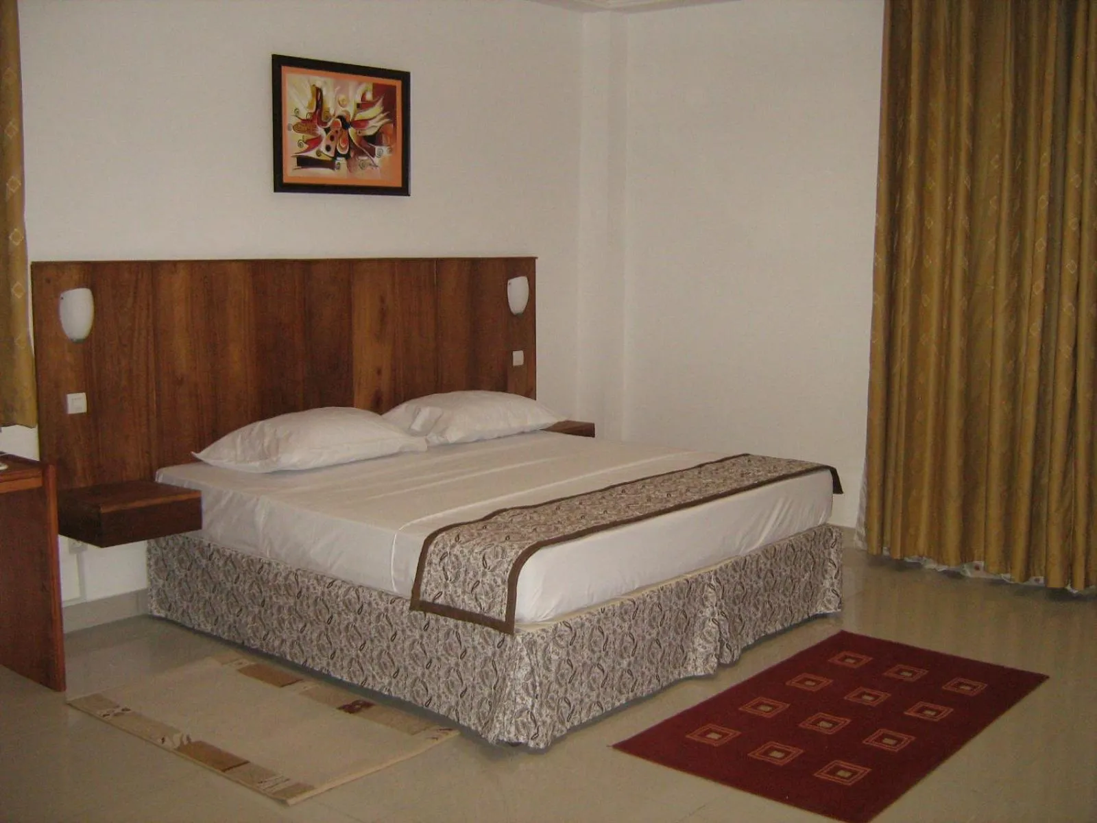 Bed in Rosalie's Suites