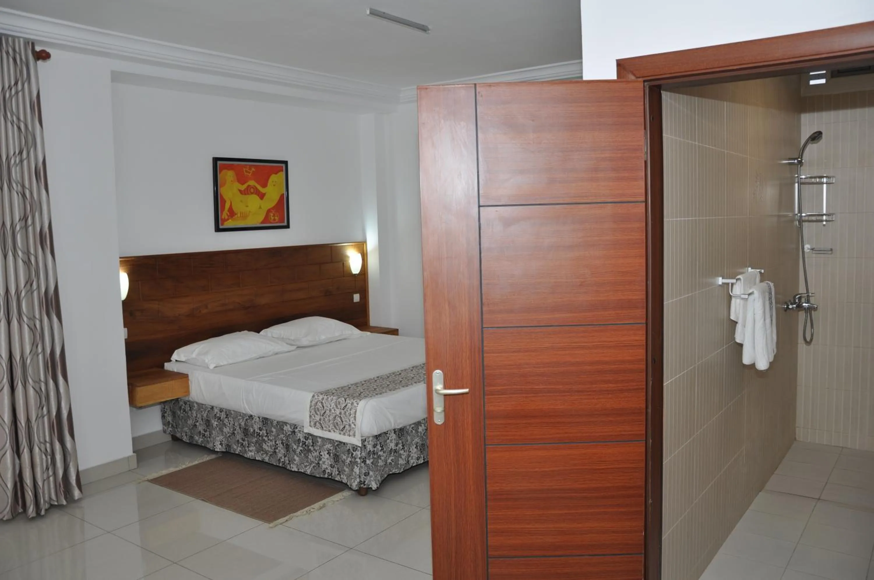 Photo of the whole room, Bed in Rosalie's Suites