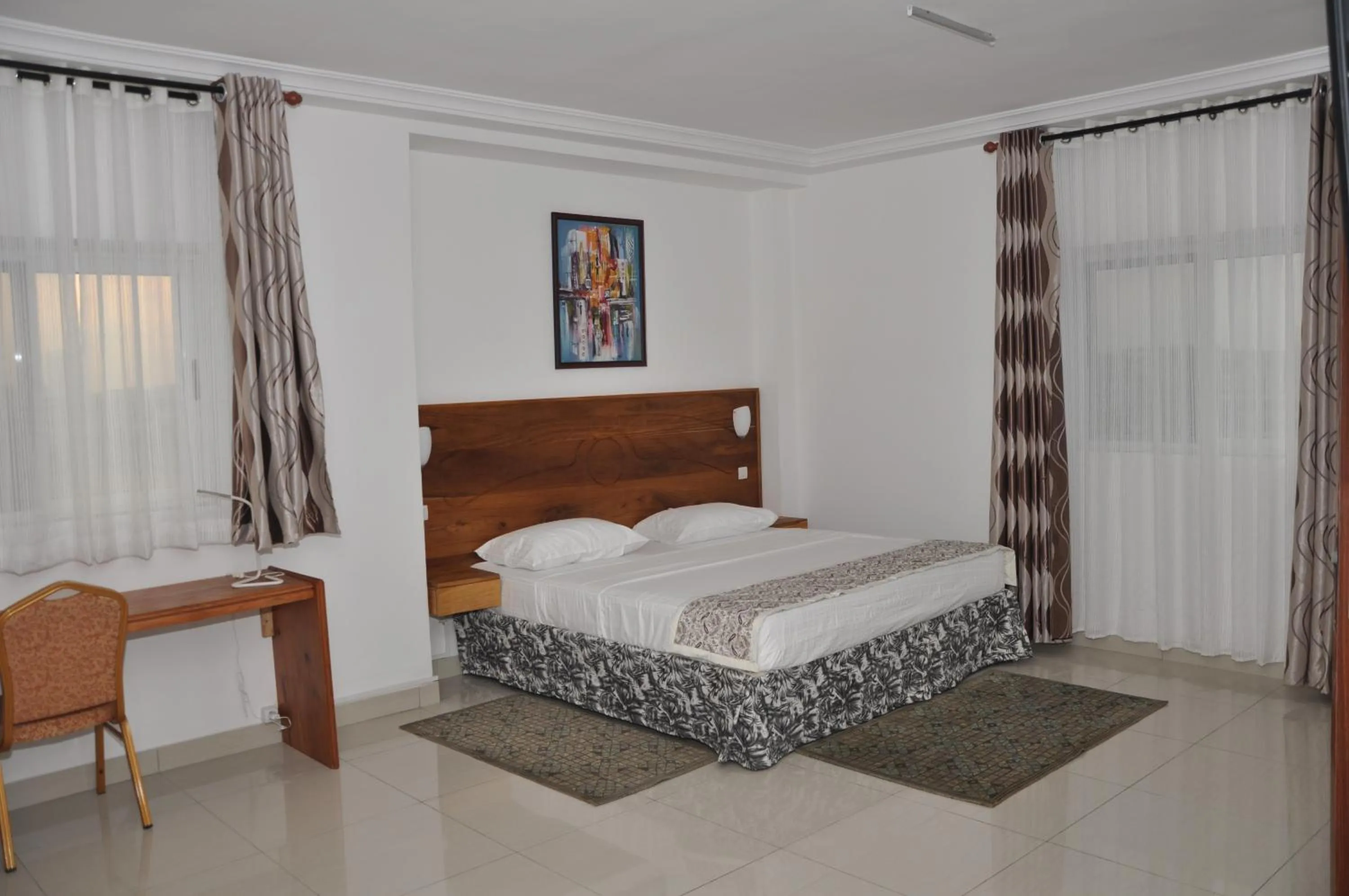 Bed in Rosalie's Suites