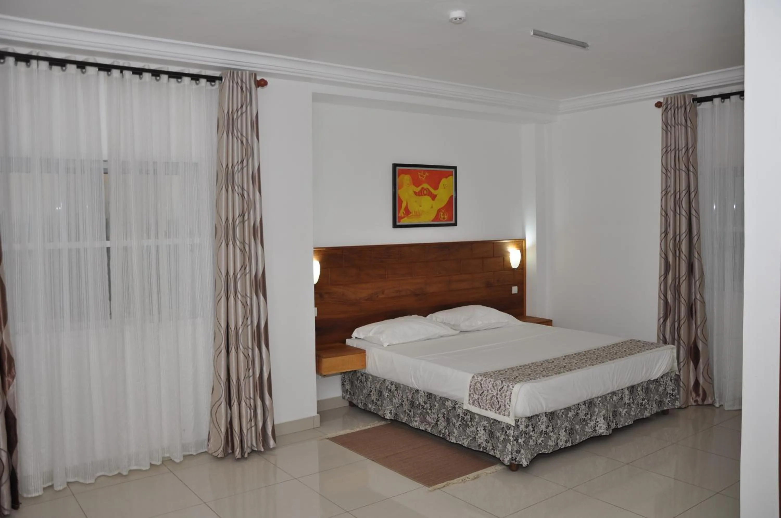 Bed in Rosalie's Suites