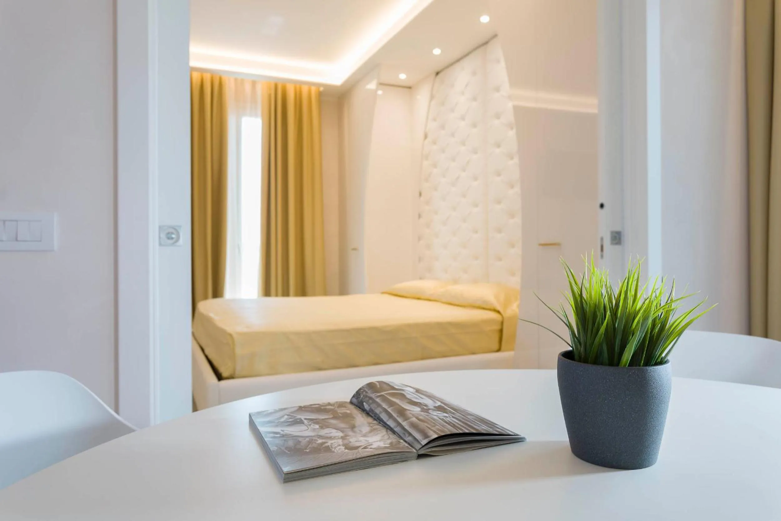 Bed in White Suite & Apartments