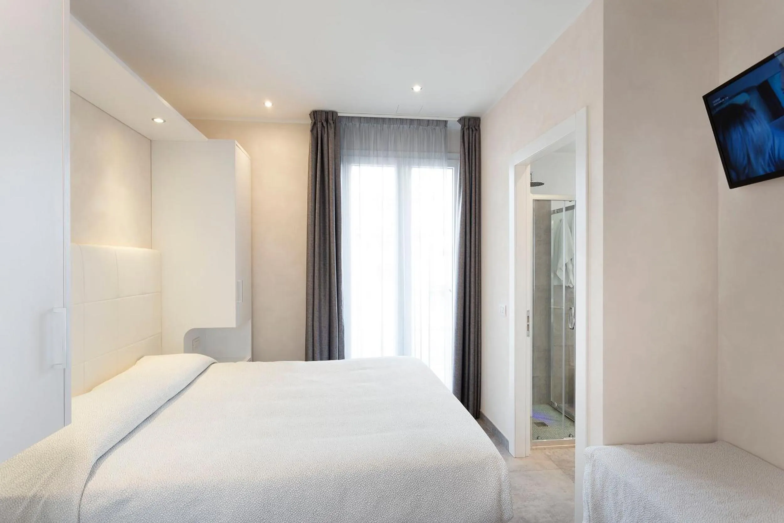 Bed in White Suite & Apartments