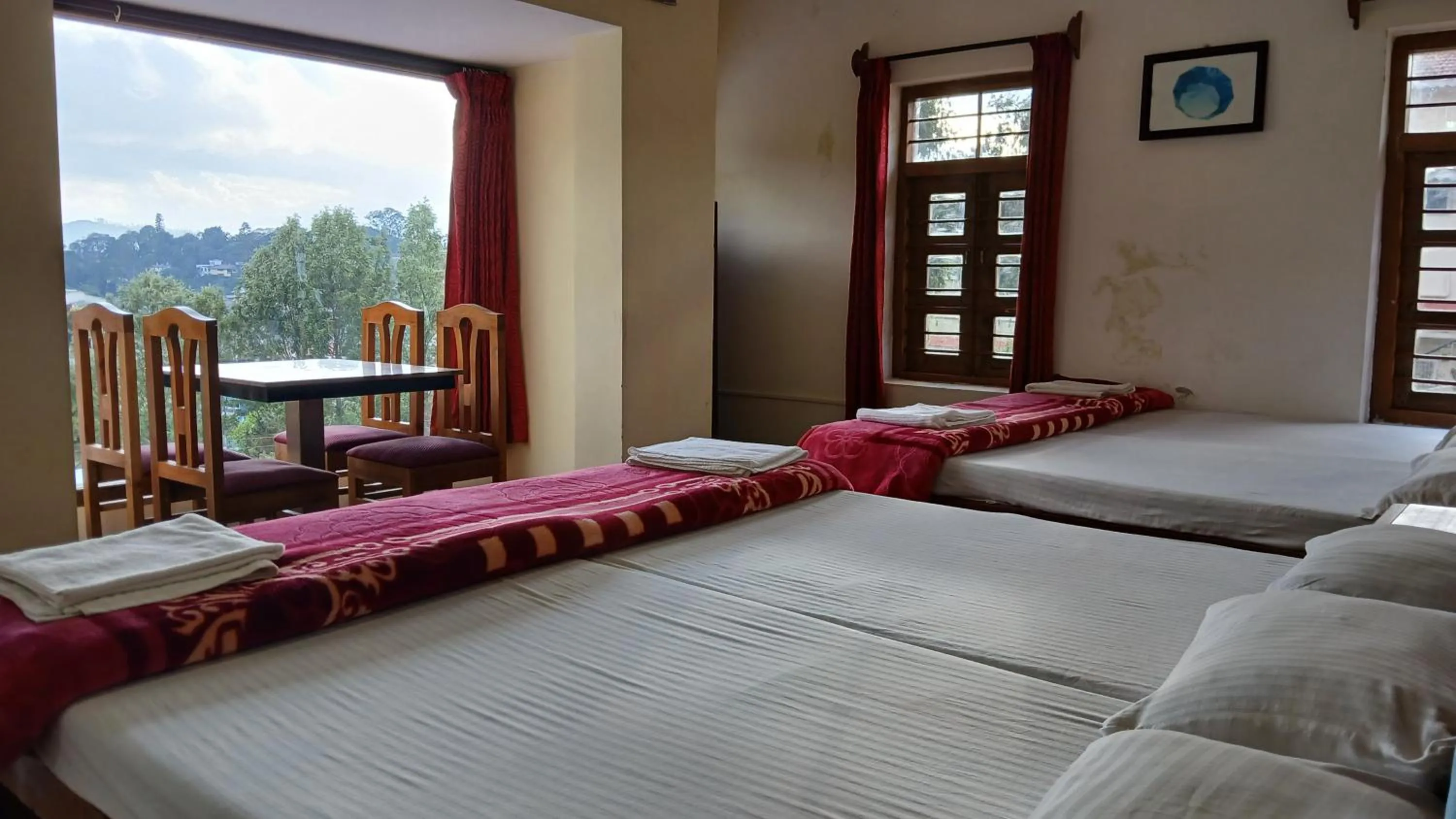 Bed in Satya Anand Cottage Pure Veg and Non Alcoholic Hotel