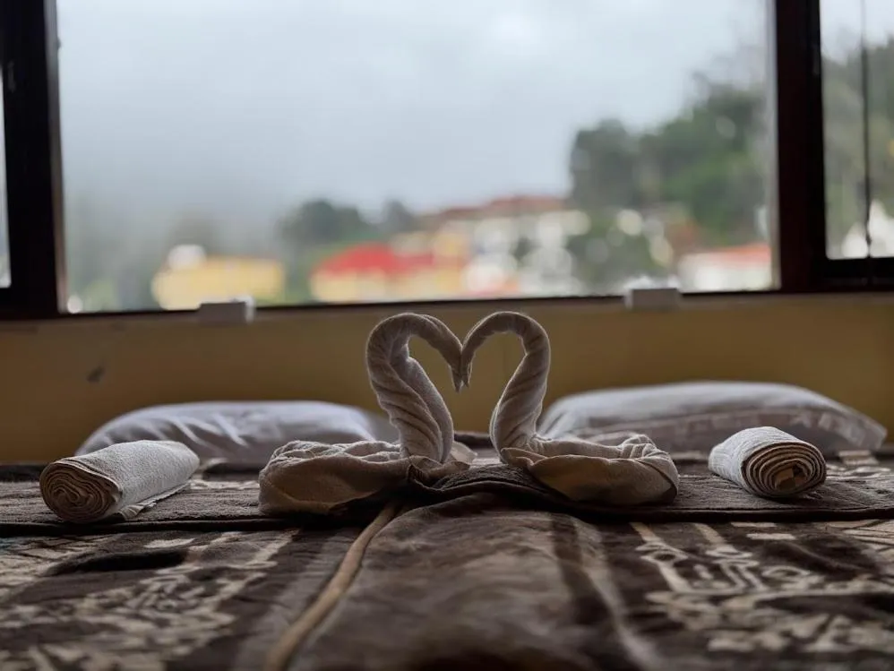 Bed in Satya Anand Cottage Pure Veg and Non Alcoholic Hotel