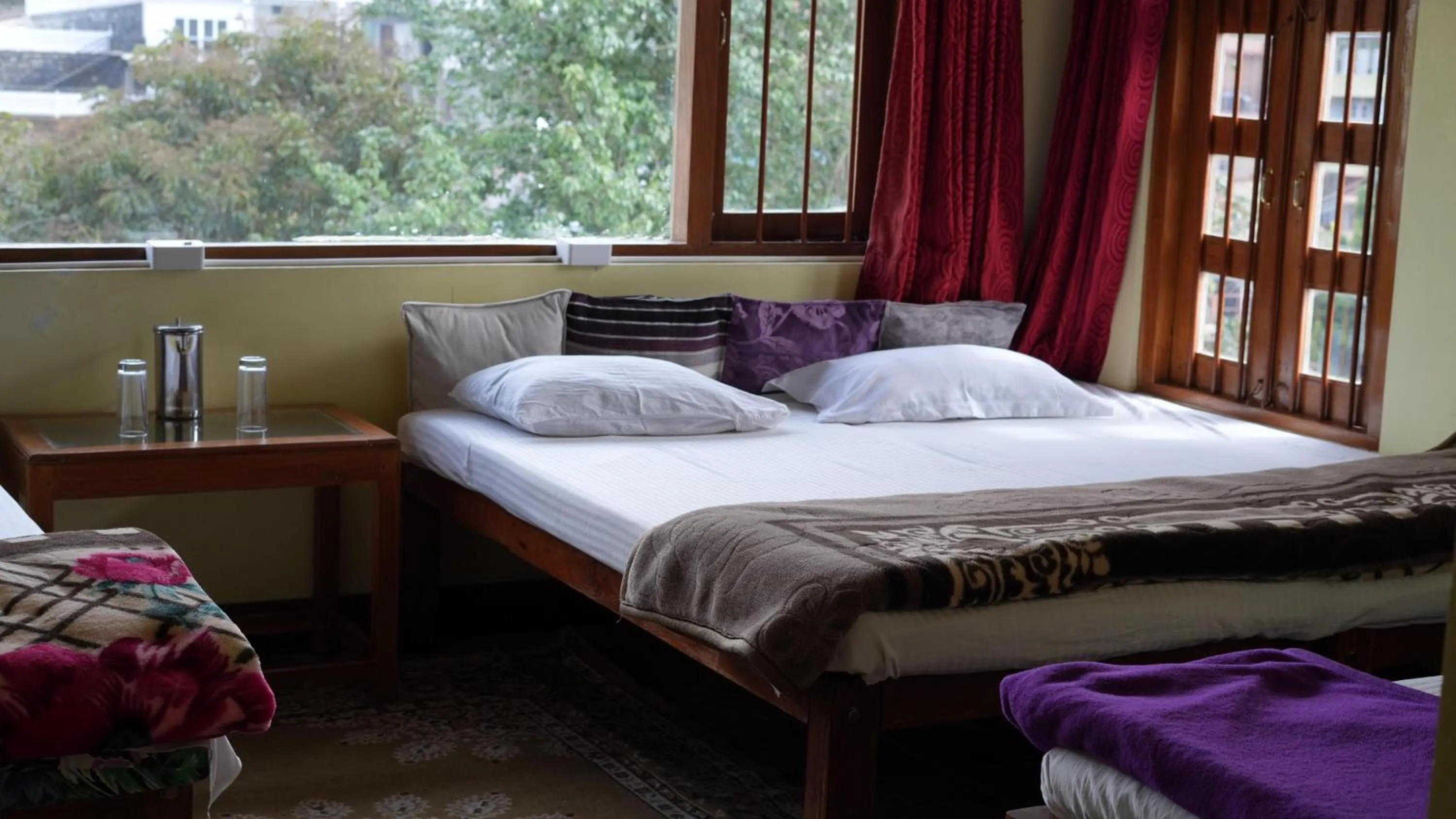 Bed in Satya Anand Cottage Pure Veg and Non Alcoholic Hotel