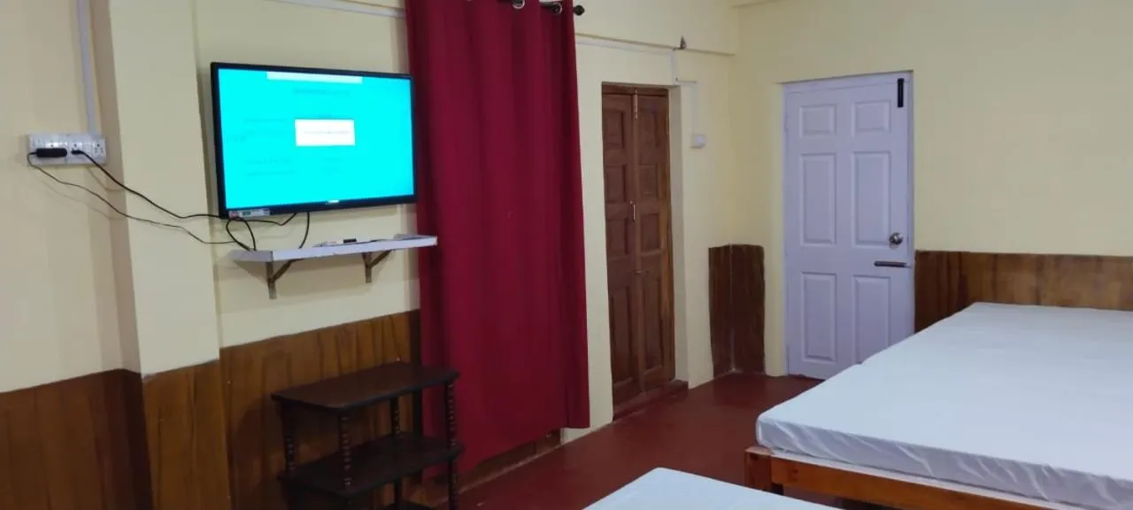 Bed in Satya Anand Cottage Pure Veg and Non Alcoholic Hotel