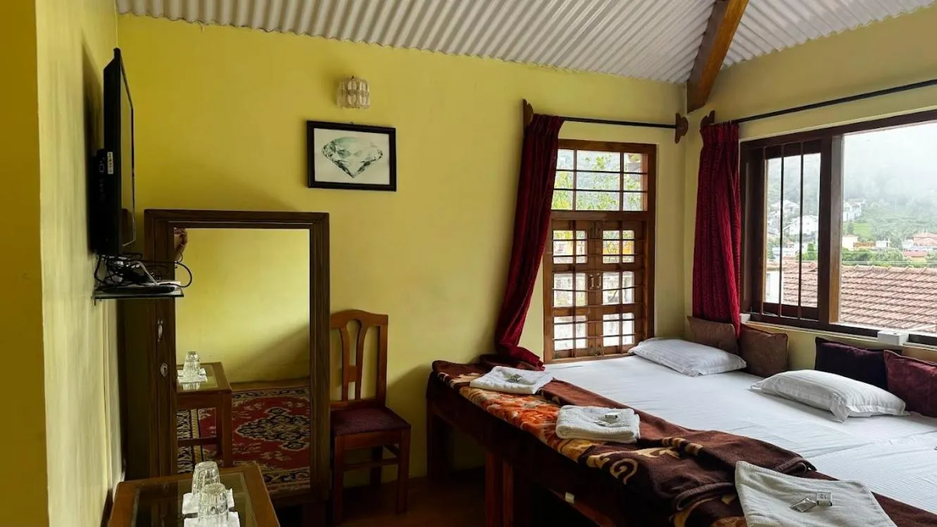 Bed in Satya Anand Cottage Pure Veg and Non Alcoholic Hotel