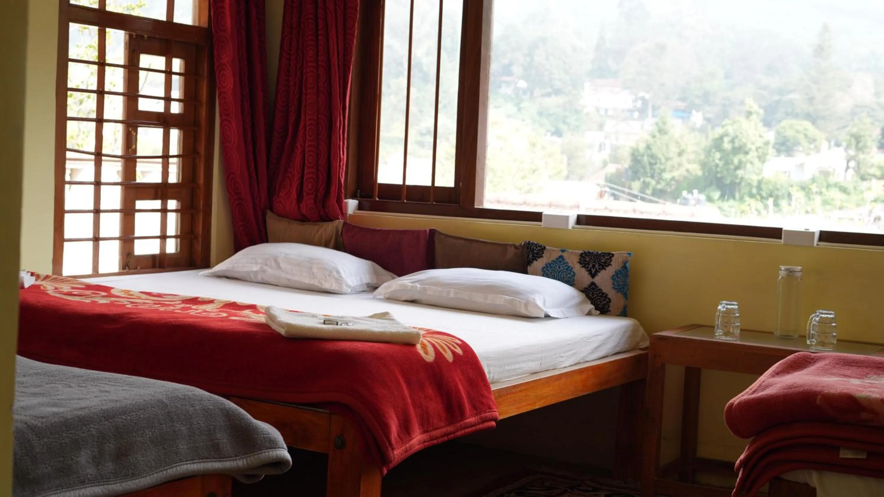 Bed in Satya Anand Cottage Pure Veg and Non Alcoholic Hotel
