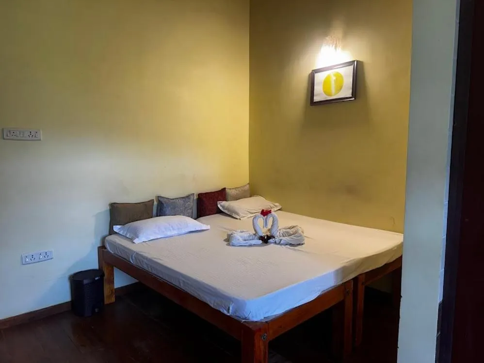 Bed in Satya Anand Cottage Pure Veg and Non Alcoholic Hotel