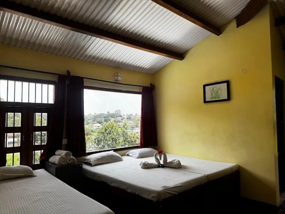 Bed in Satya Anand Cottage Pure Veg and Non Alcoholic Hotel