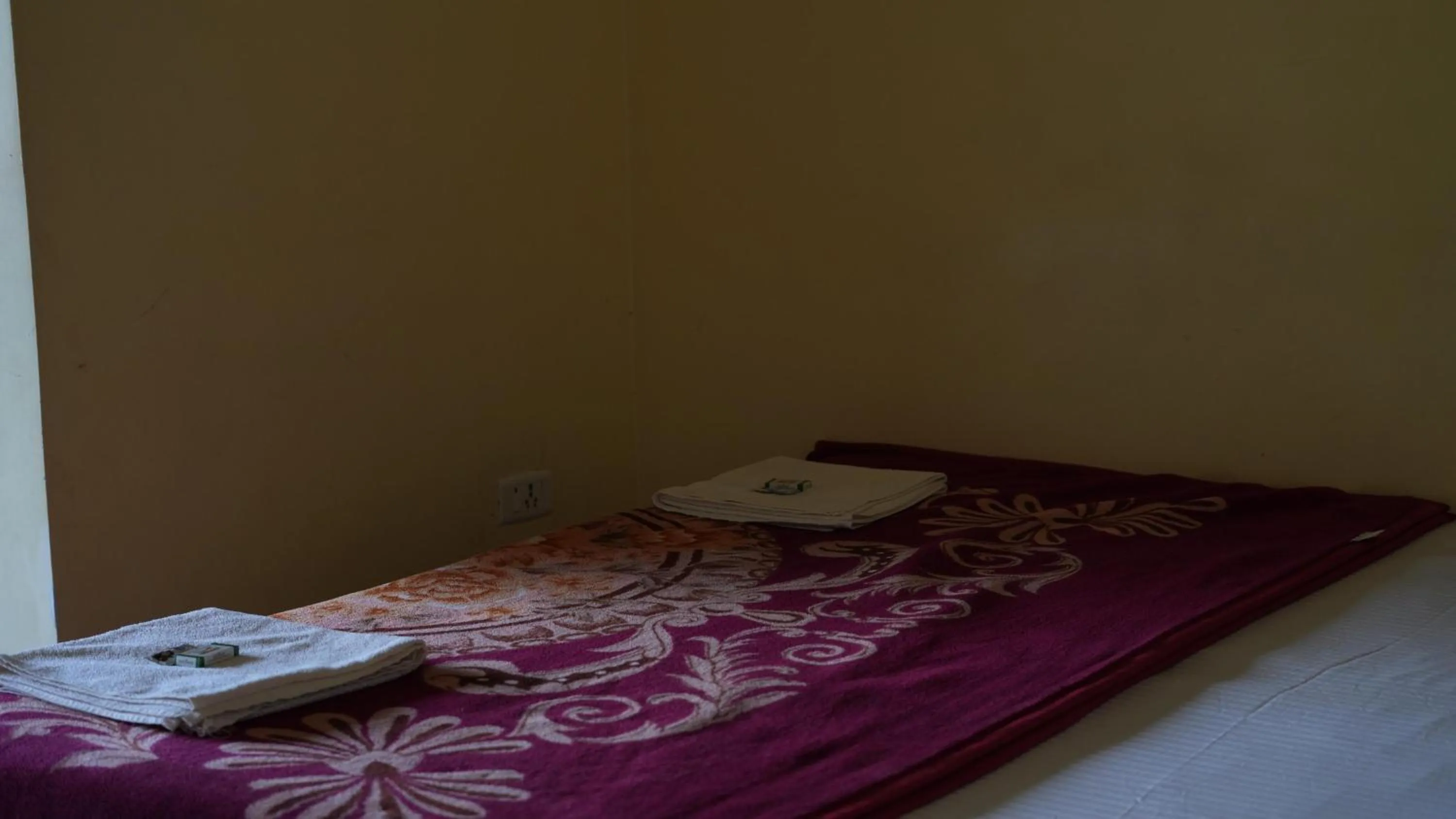 Bed in Satya Anand Cottage Pure Veg and Non Alcoholic Hotel