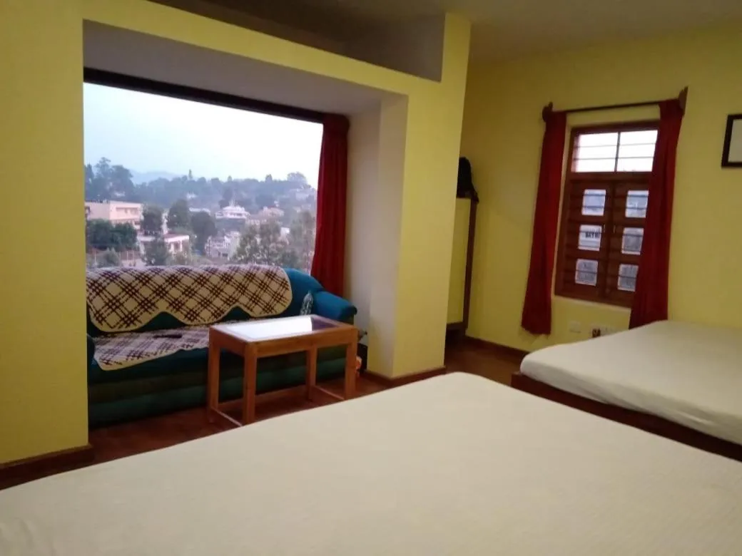 Bed in Satya Anand Cottage Pure Veg and Non Alcoholic Hotel