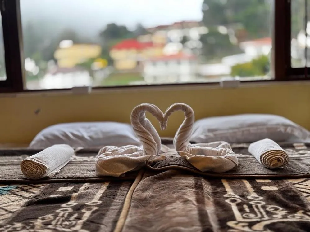 Bed in Satya Anand Cottage Pure Veg and Non Alcoholic Hotel